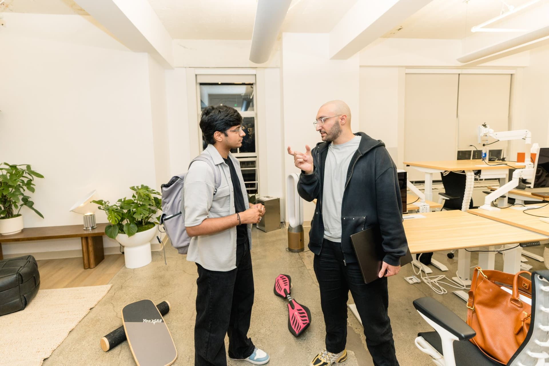 Small group networking near the desks at Gumloop's San Francisco office after the program