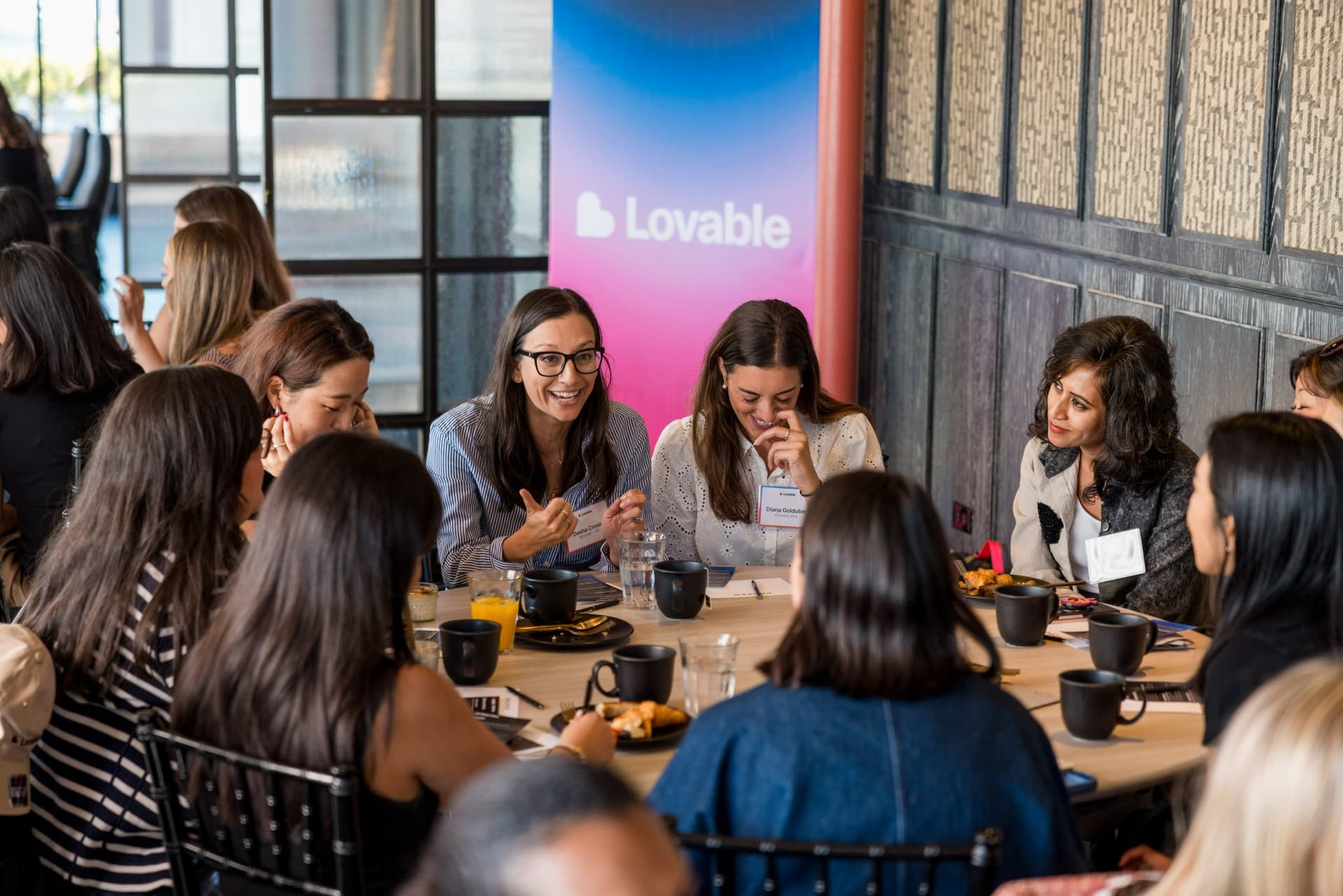 Roundtable discussion beside the Lovable banner at Lovable x Wispr Flow's Built on Her Terms brunch roundtable during SF Tech Week 2026 in San Francisco by JY Studio