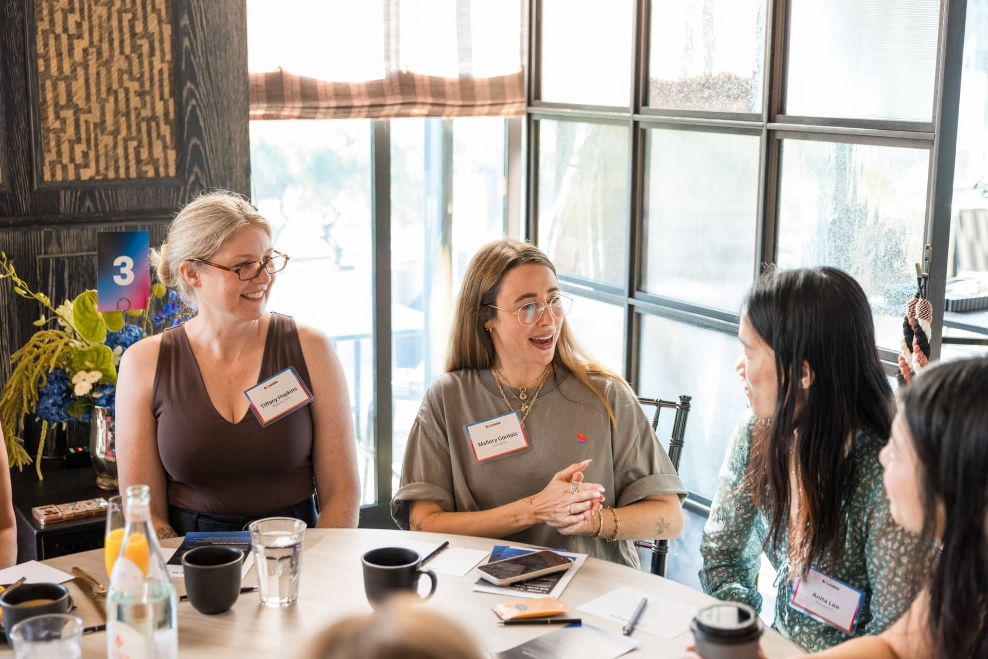 Guests sharing ideas at table three during the women in AI discussion at Lovable x Wispr Flow's Built on Her Terms brunch roundtable during SF Tech Week 2026 in San Francisco by JY Studio