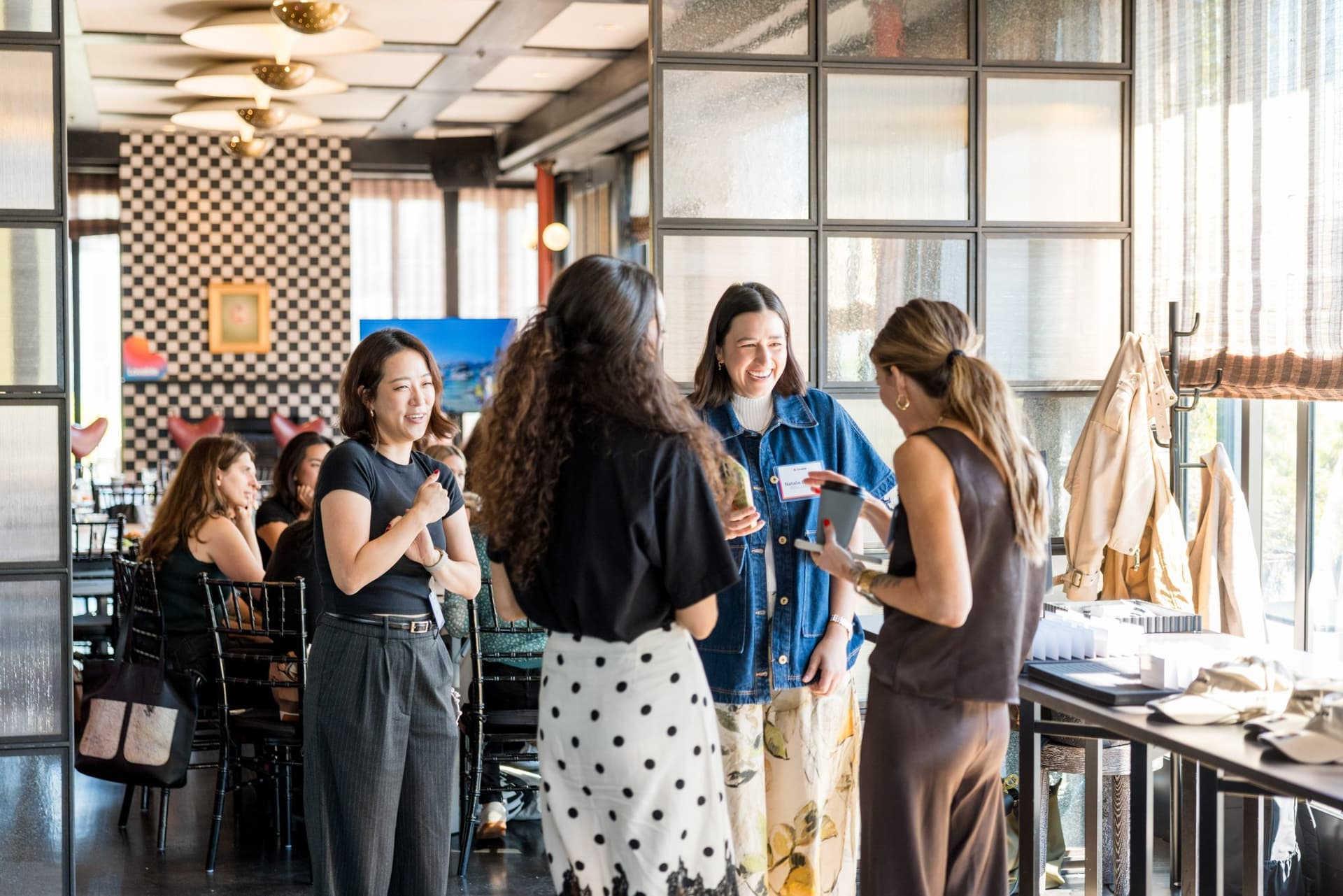 Small group of guests networking in the dining room after brunch at Lovable x Wispr Flow's Built on Her Terms brunch roundtable during SF Tech Week 2026 in San Francisco by JY Studio