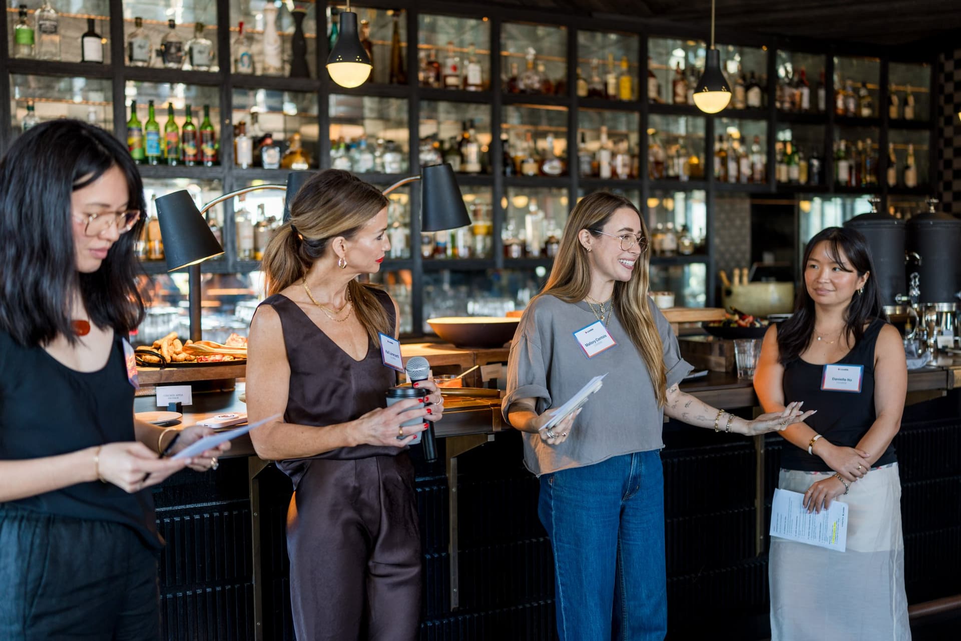 Event hosts sharing roundtable takeaways with the room at Lovable x Wispr Flow's Built on Her Terms brunch roundtable during SF Tech Week 2026 in San Francisco by JY Studio
