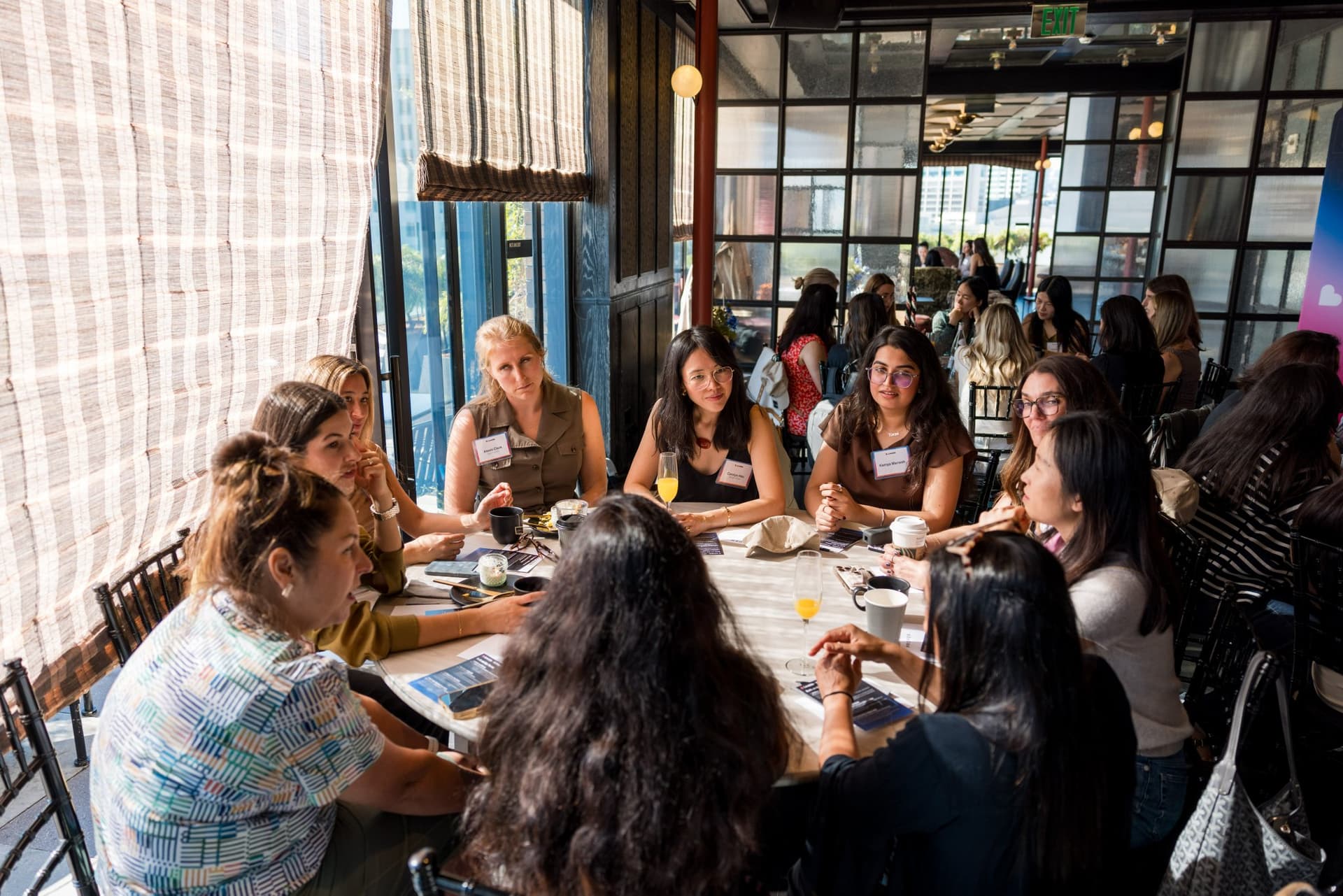 Brunch roundtable in full conversation by the windows at Lovable x Wispr Flow's Built on Her Terms brunch roundtable during SF Tech Week 2026 in San Francisco by JY Studio