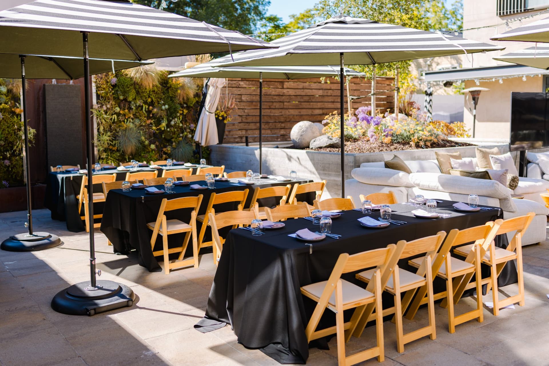 Guests seated together on the patio sofas before the Magnus fireside chat begins in Palo Alto