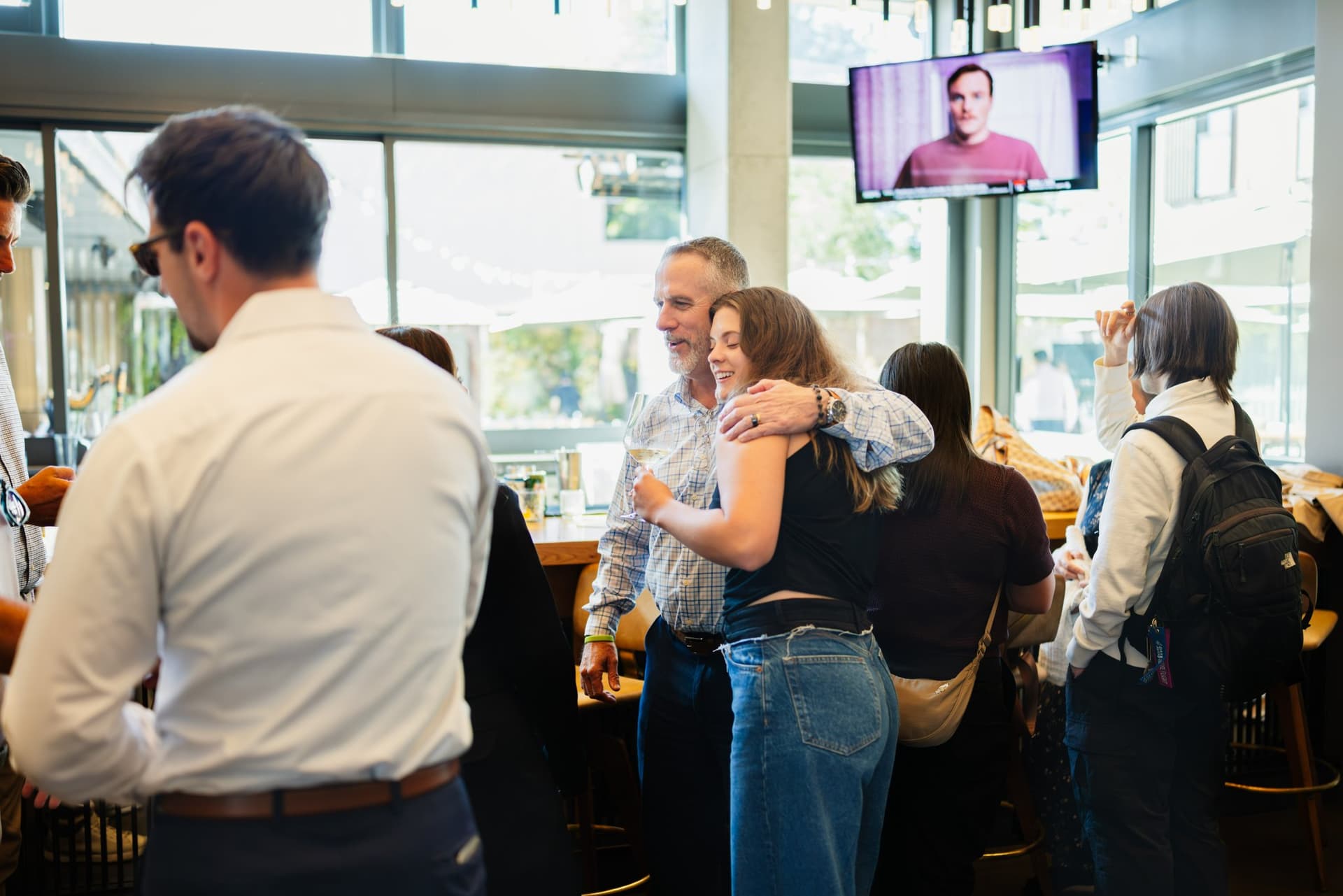 Attendees networking near the high-top cocktail tables at the Magnus event in Palo Alto