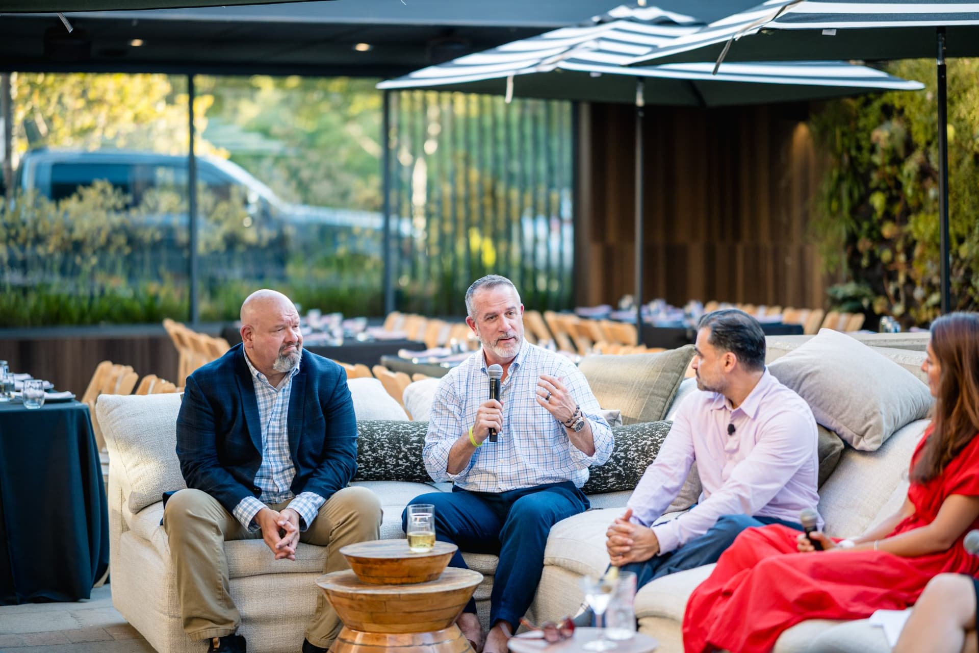 Audience members seated on patio sofas listening to the Magnus panel discussion in Palo Alto