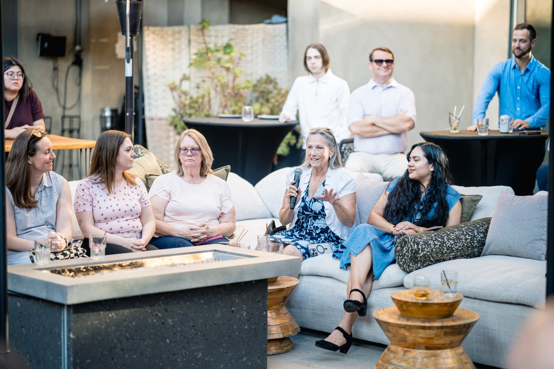Guests smiling while listening to the fireside chat at the Magnus networking event in Palo Alto
