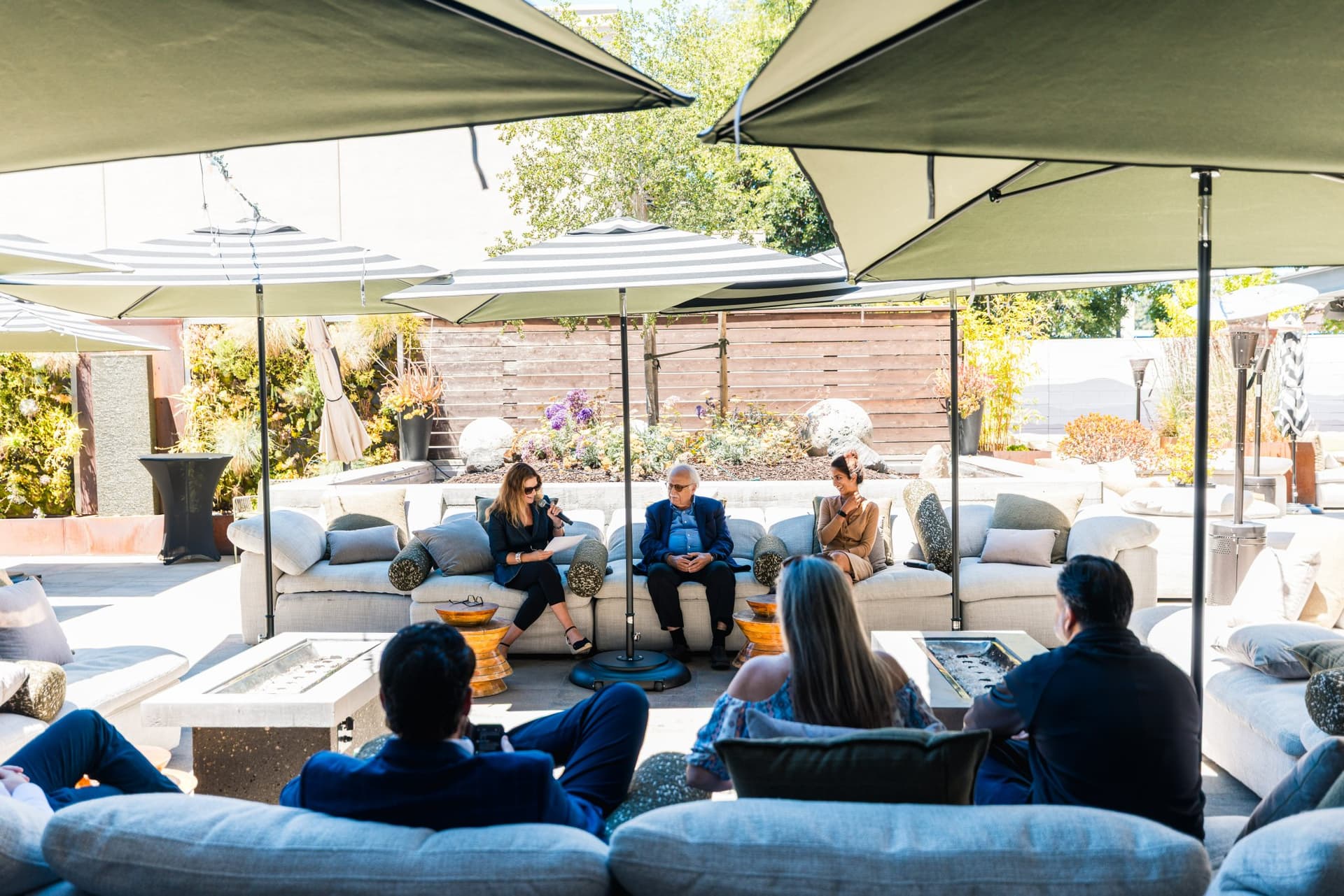 Wide view of the patio lounge audience during the Magnus fireside chat panel in Palo Alto