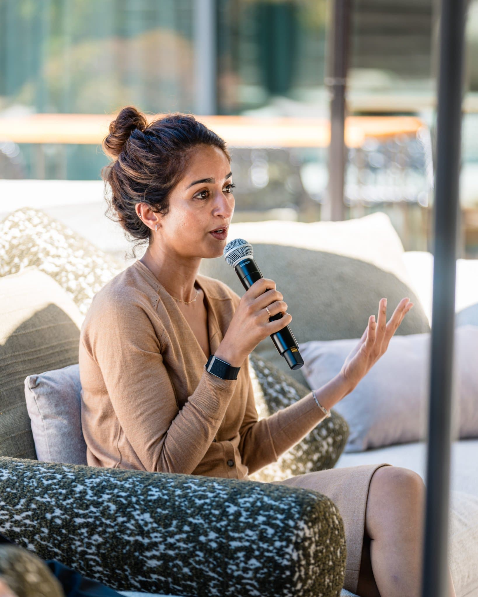 Member speaking to the group with hands raised during closing remarks at the Magnus event in Palo Alto