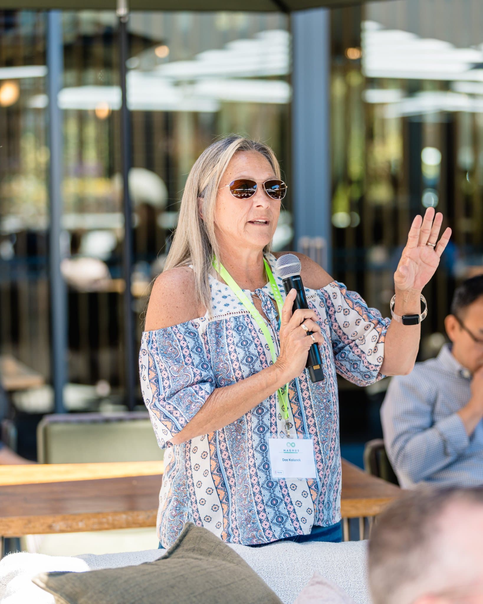 Guest wearing a Magnus name badge sharing remarks with the group in Palo Alto