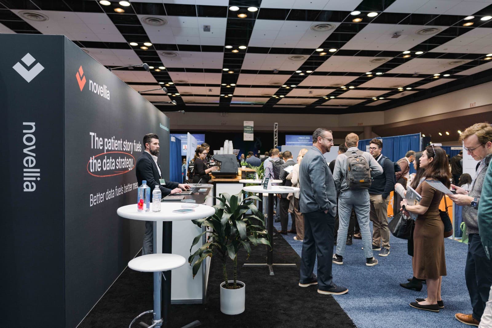 Novellia team demonstrating precision medicine technology at PMWC 2026 booth in Silicon Valley by JY Studio