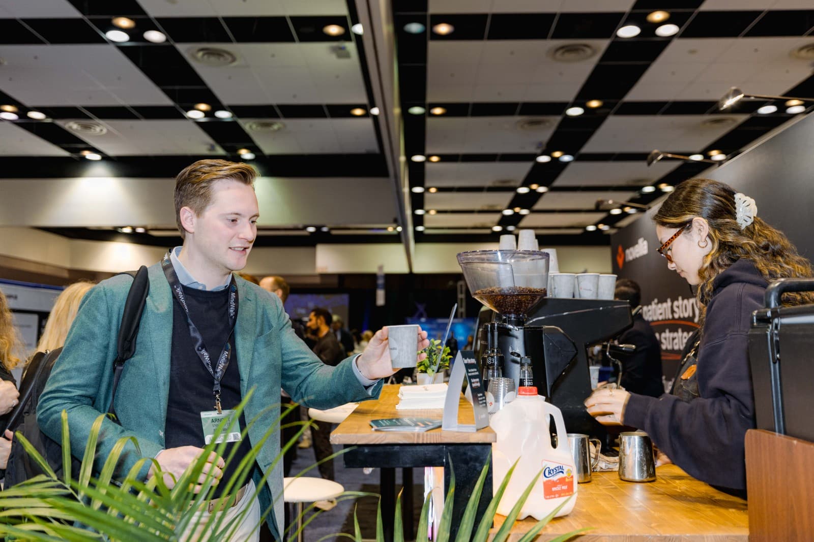 Candid networking moment between attendees at PMWC 2026 conference in Santa Clara Bay Area by JY Studio