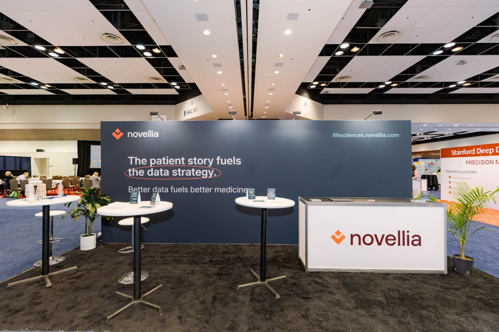 Speaker presenting biotech research at PMWC 2026 conference stage in Santa Clara by JY Studio