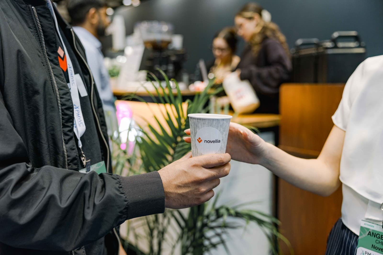 Group discussion at Novellia exhibit during PMWC 2026 in Santa Clara Silicon Valley by JY Studio