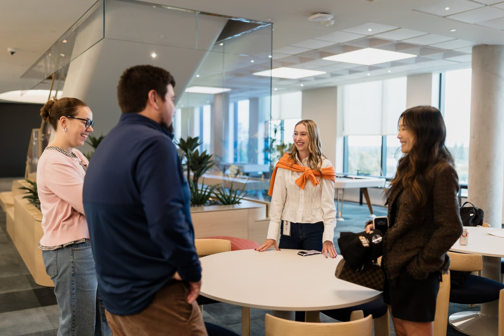 PwC team members chatting in the office lounge before the program at the PwC x 49ers event at PwC Silicon Valley in San Jose by JY Studio