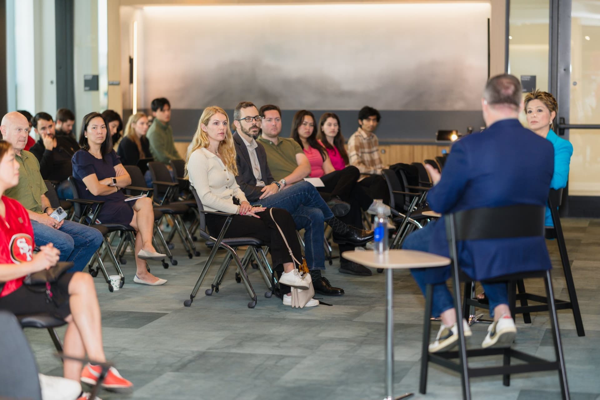 Attendees listening to the fireside chat from the audience at the PwC x 49ers event at PwC Silicon Valley in San Jose by JY Studio