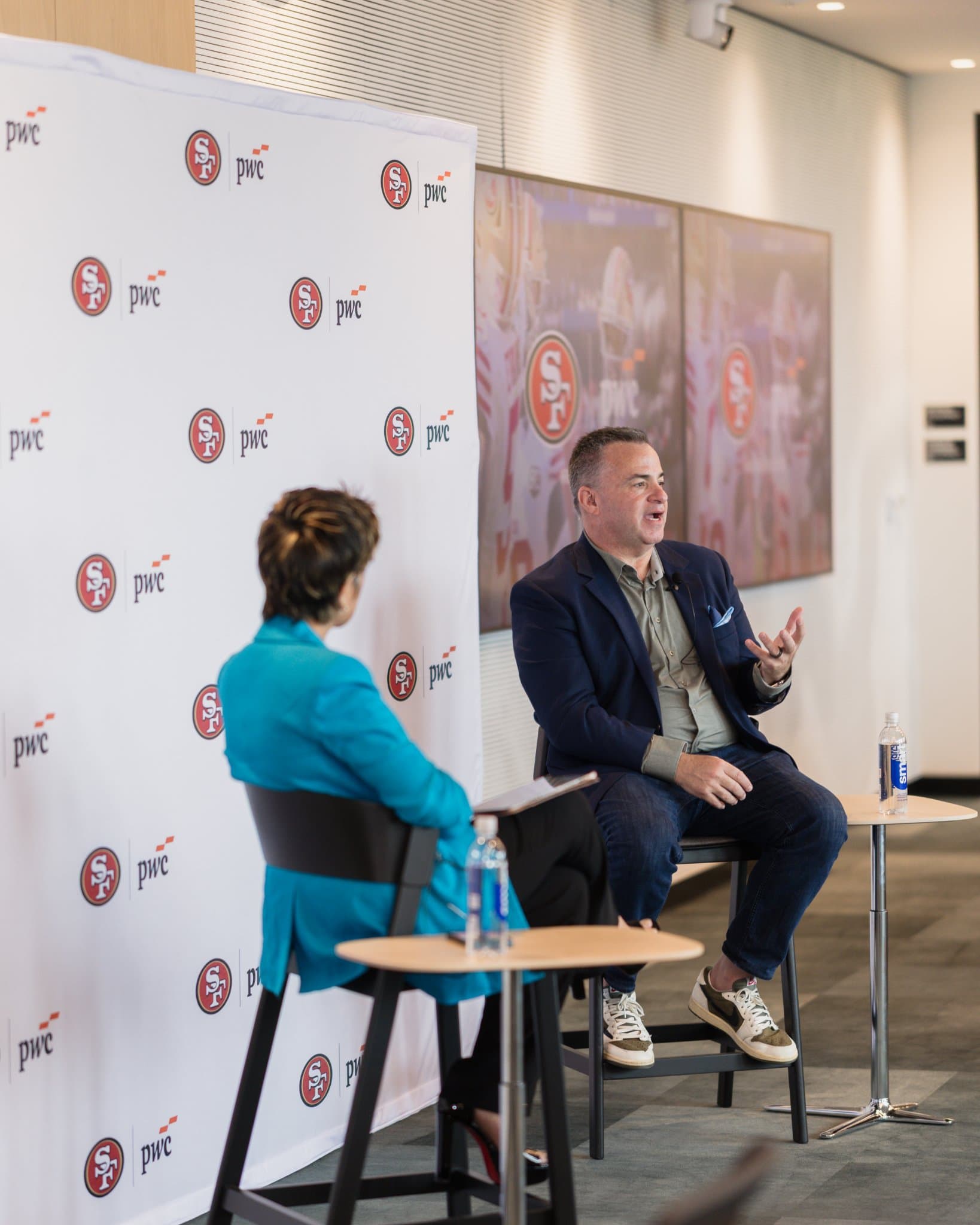 Guest speaker laughing while answering a question during the fireside chat at the PwC x 49ers event at PwC Silicon Valley in San Jose by JY Studio