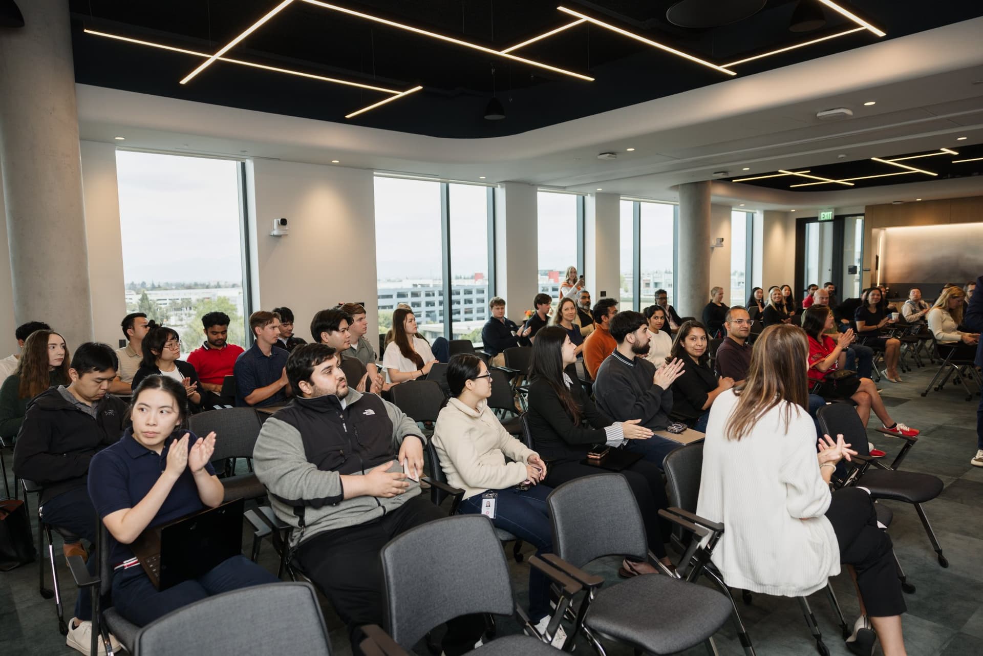 Attendees applauding during the program at the PwC x 49ers event at PwC Silicon Valley in San Jose by JY Studio