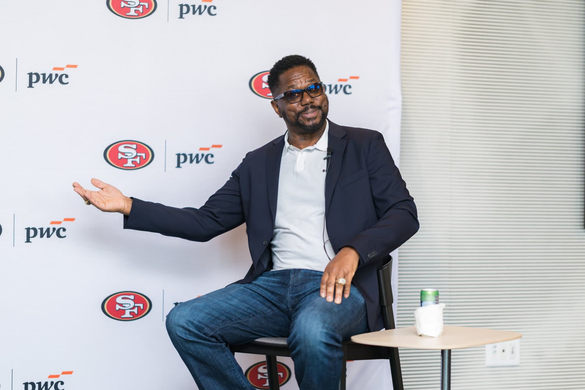 49ers legend gesturing while telling a story during the fireside chat at the PwC x 49ers event at PwC Silicon Valley in San Jose by JY Studio
