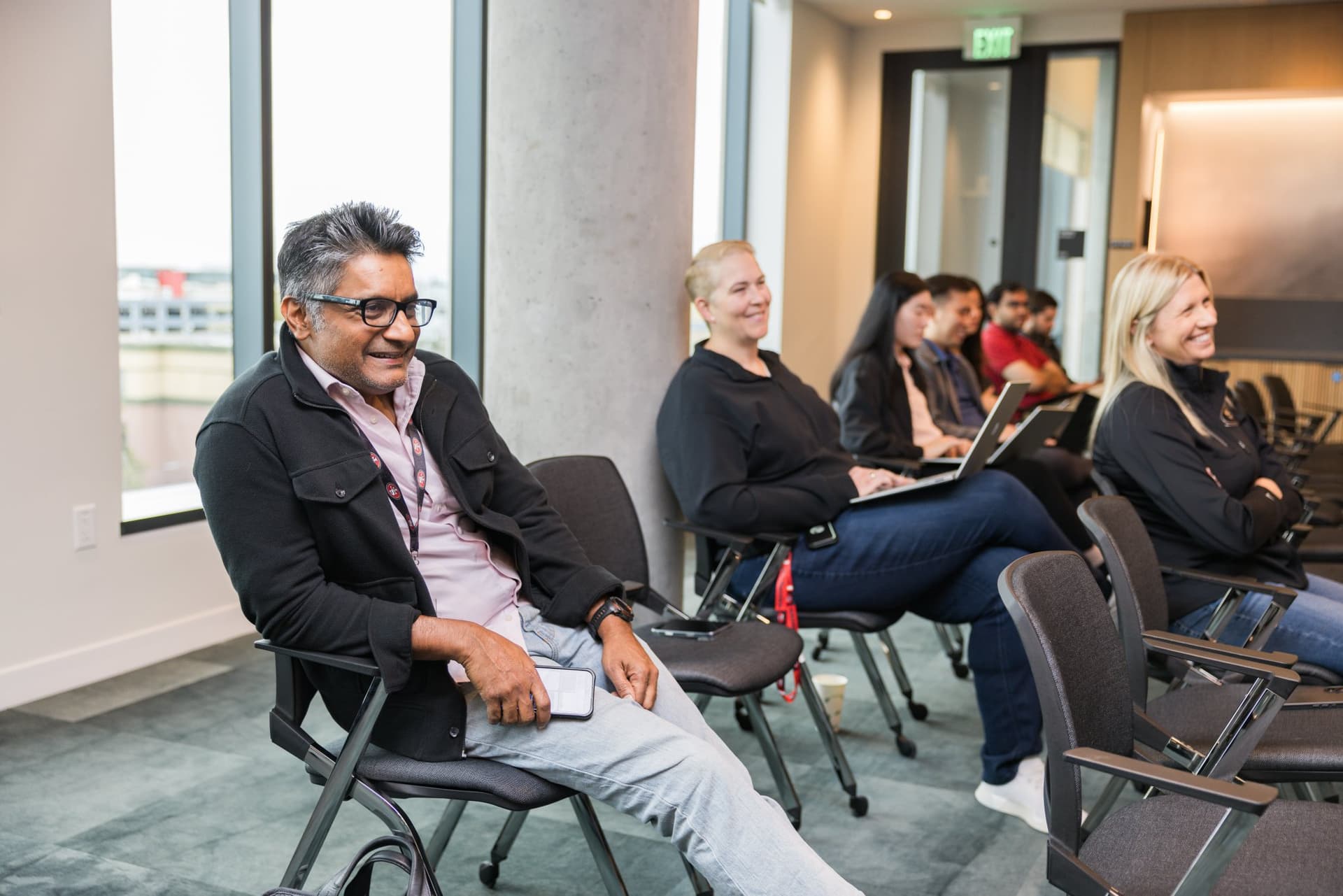 Attendee laughing during the fireside chat at the PwC x 49ers event at PwC Silicon Valley in San Jose by JY Studio