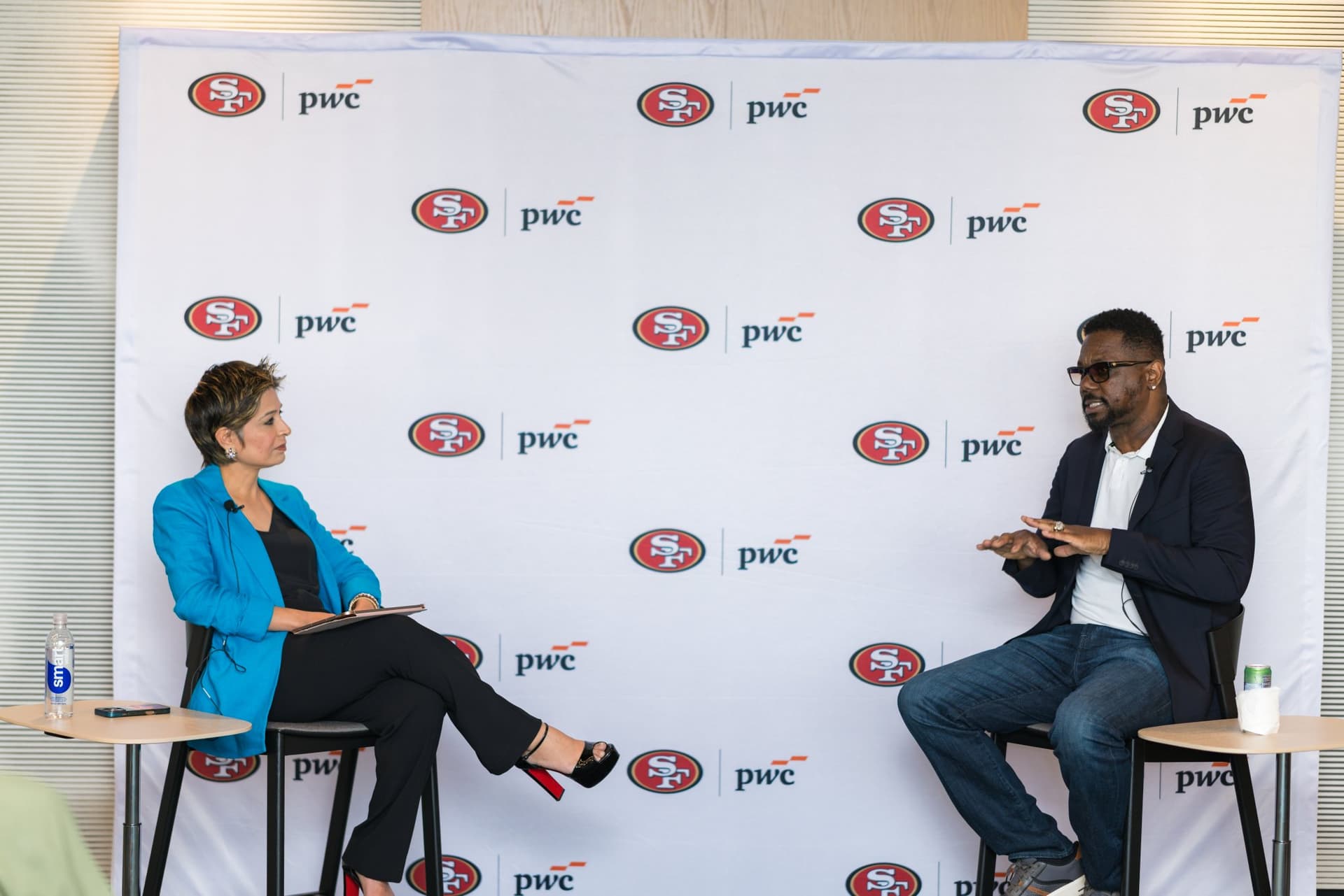 49ers legend speaking with the moderator on stage at the PwC x 49ers event at PwC Silicon Valley in San Jose by JY Studio