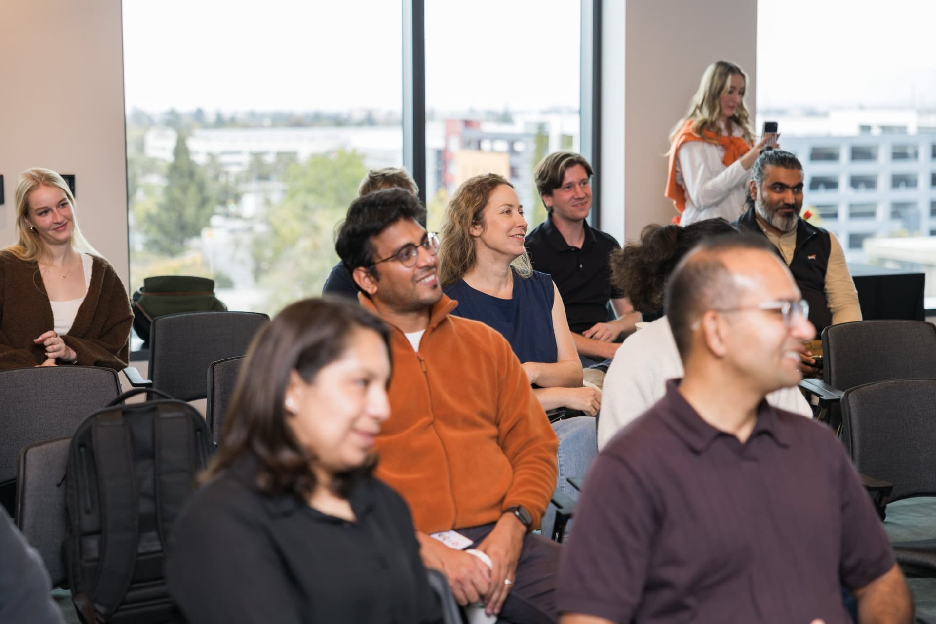 Attendees smiling and engaged during the program at the PwC x 49ers event at PwC Silicon Valley in San Jose by JY Studio