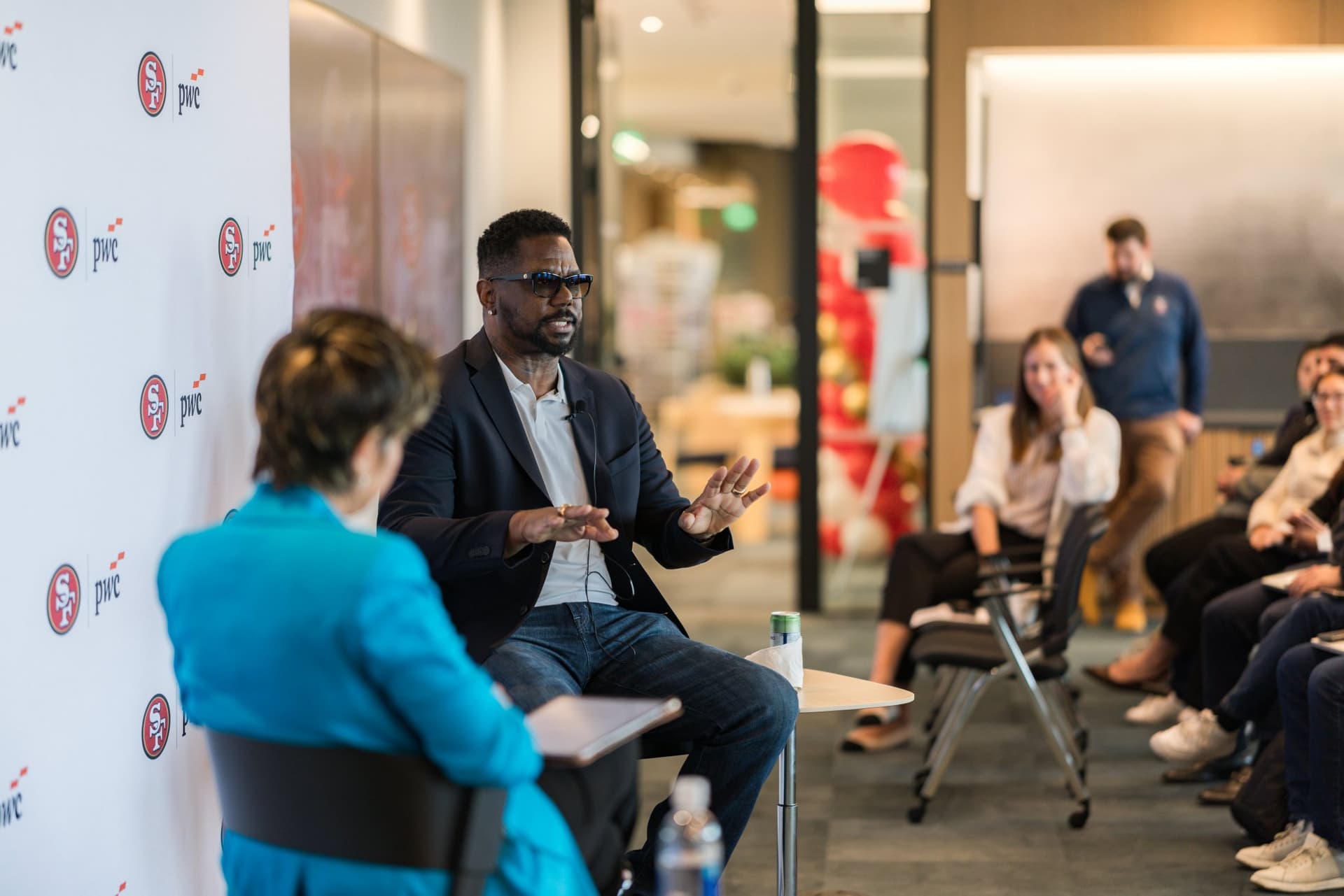 49ers legend speaking to the moderator and audience during the fireside chat at the PwC x 49ers event at PwC Silicon Valley in San Jose by JY Studio