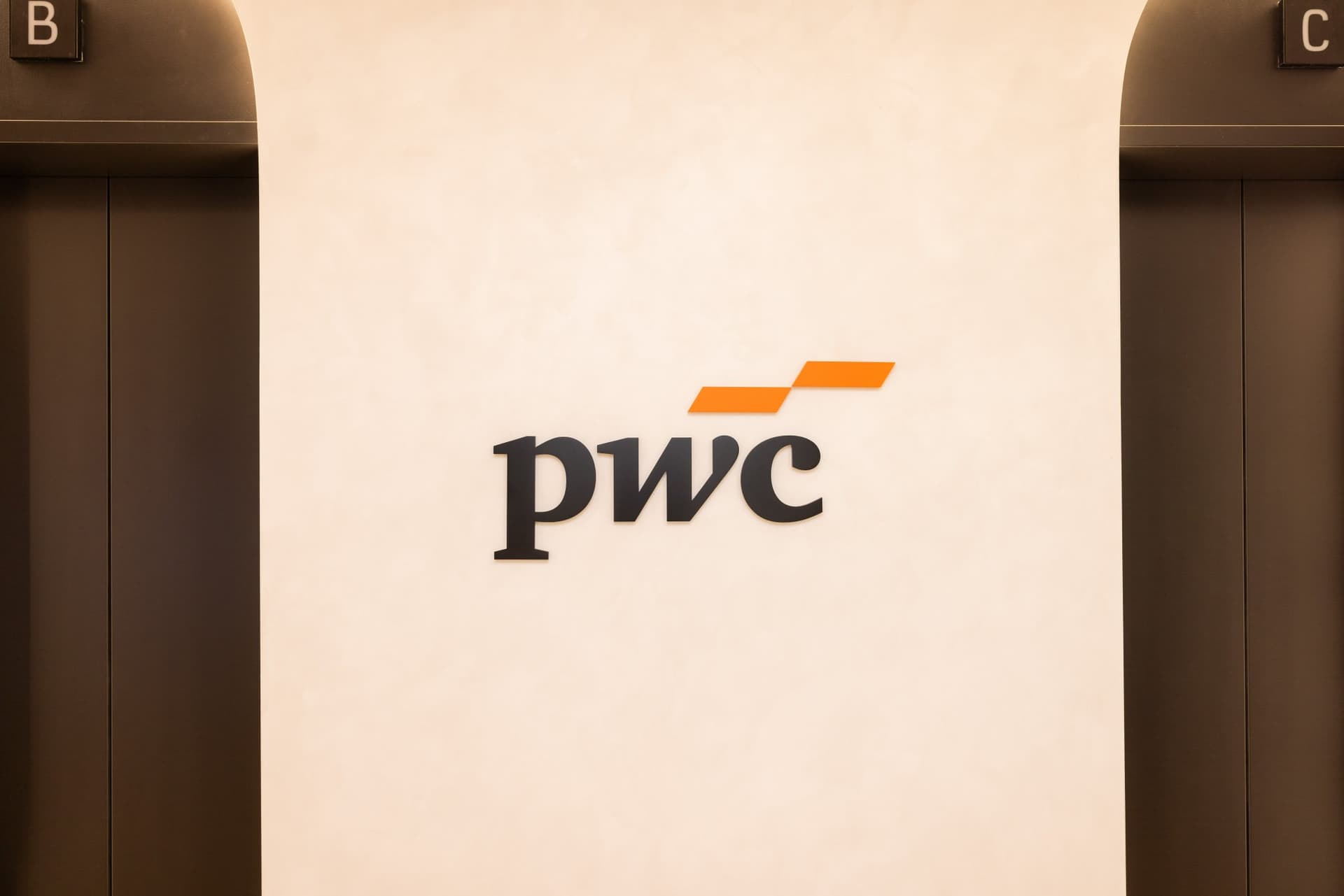 PwC logo wall in the PwC Silicon Valley office lobby at the PwC x 49ers event at PwC Silicon Valley in San Jose by JY Studio