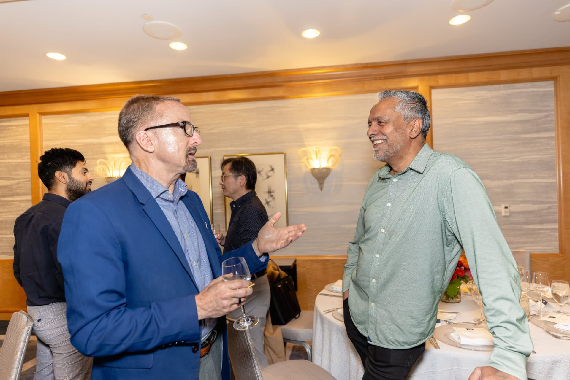 Executives networking near the reception table at the Select World Services event in San Francisco