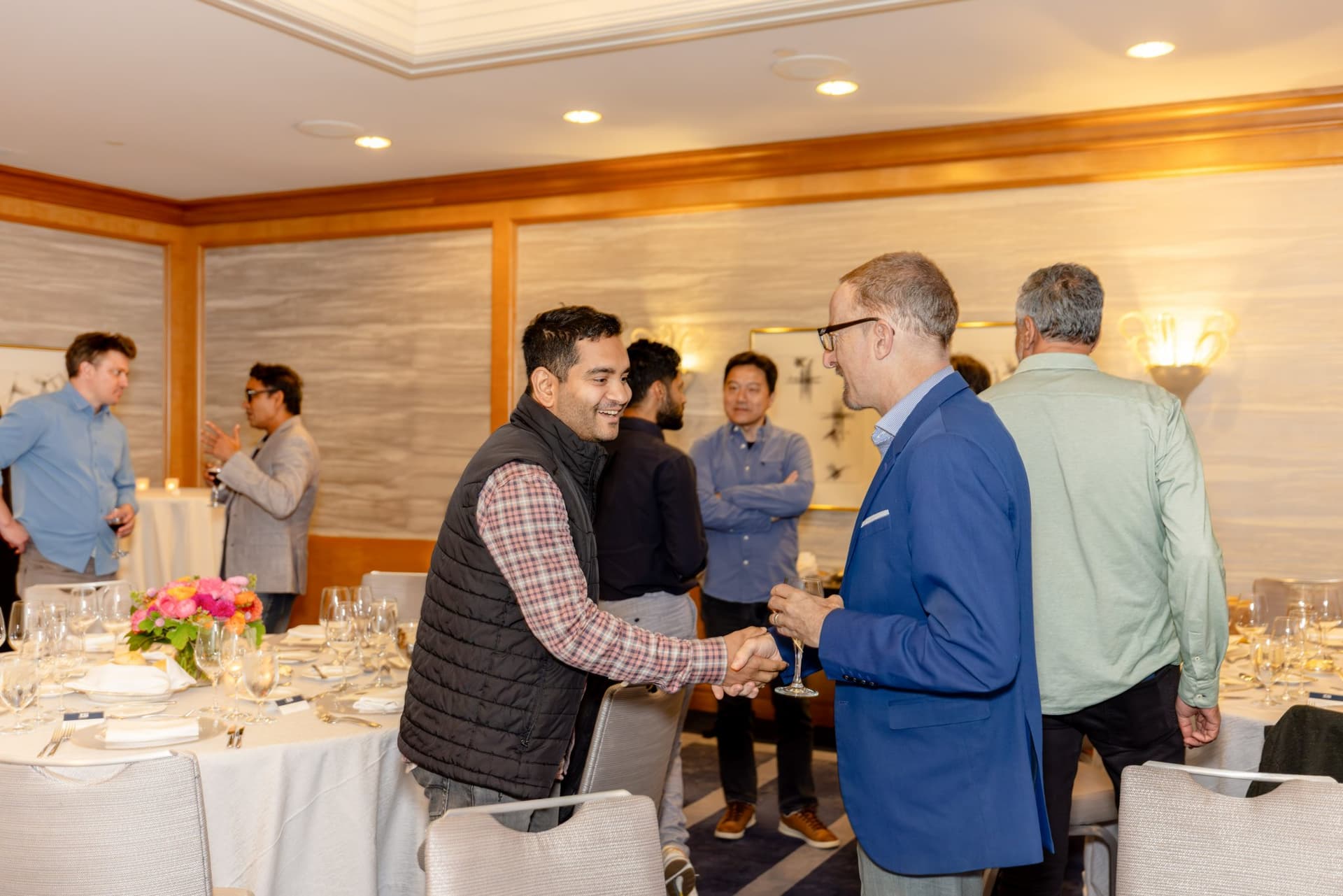 Guests smiling and chatting during the pre-dinner reception at the Select World Services executive dinner in San Francisco