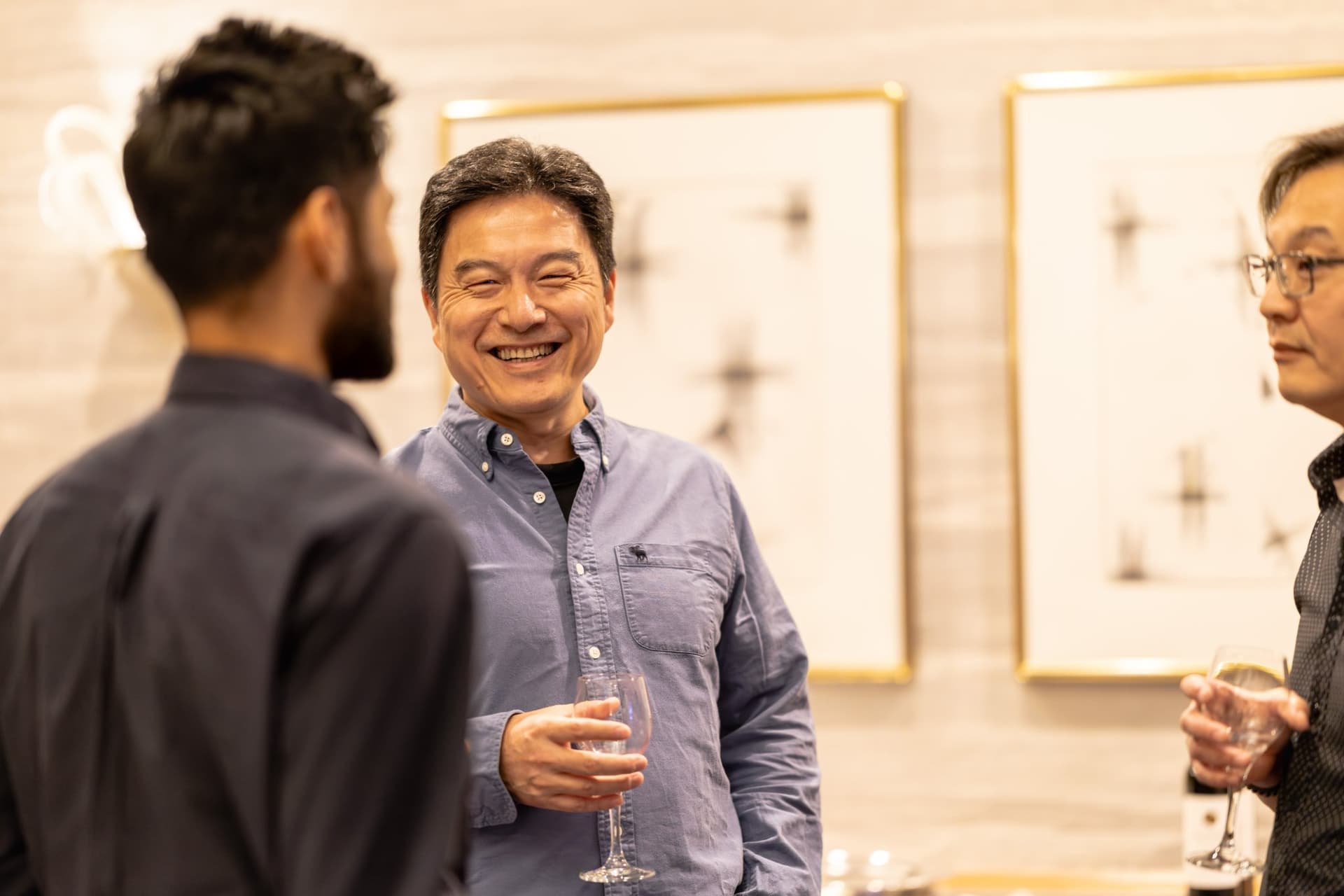 Candid laughter between industry leaders at the Select World Services cybersecurity dinner in San Francisco