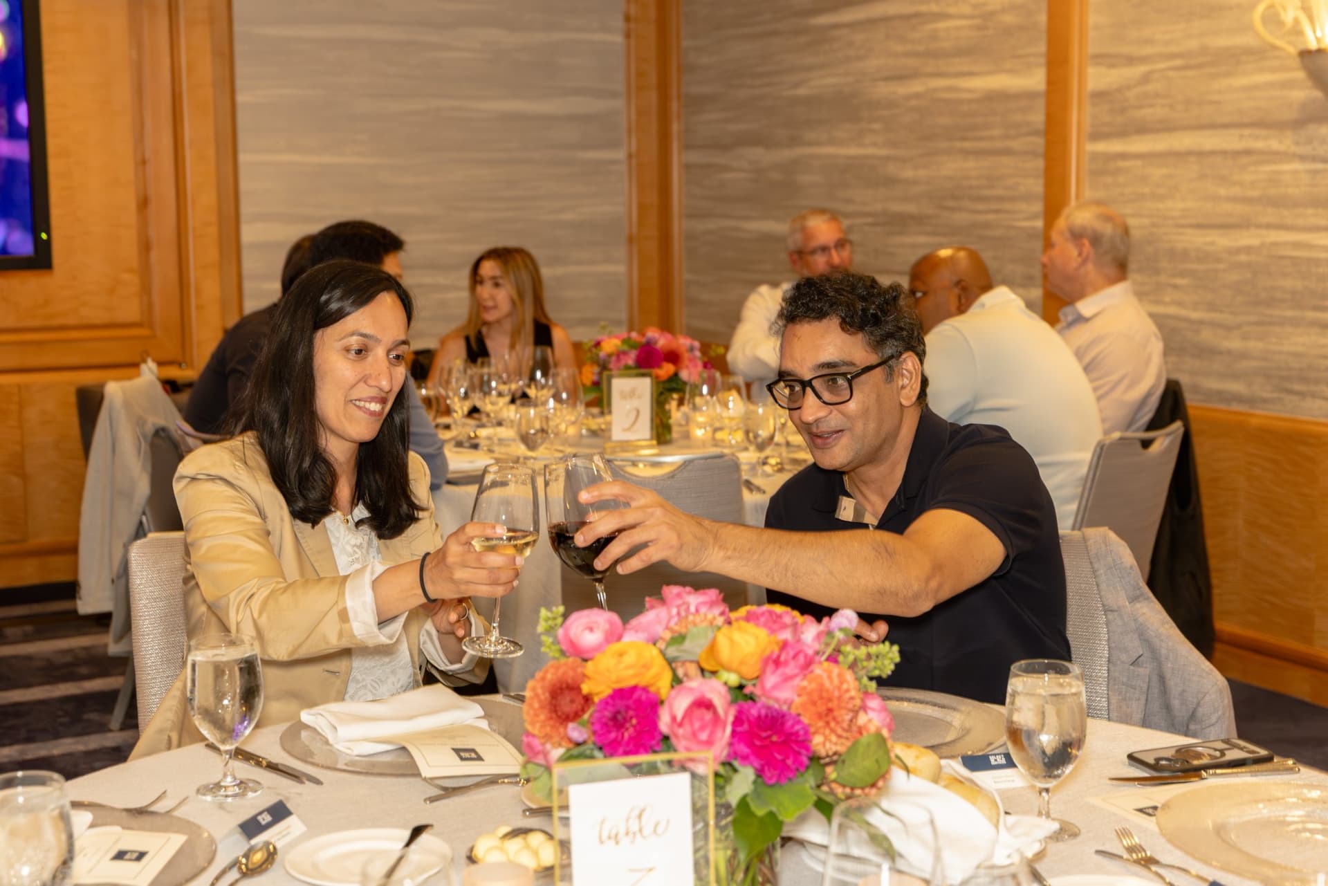 Guest sharing a toast with fellow attendees at the Select World Services executive dinner in San Francisco