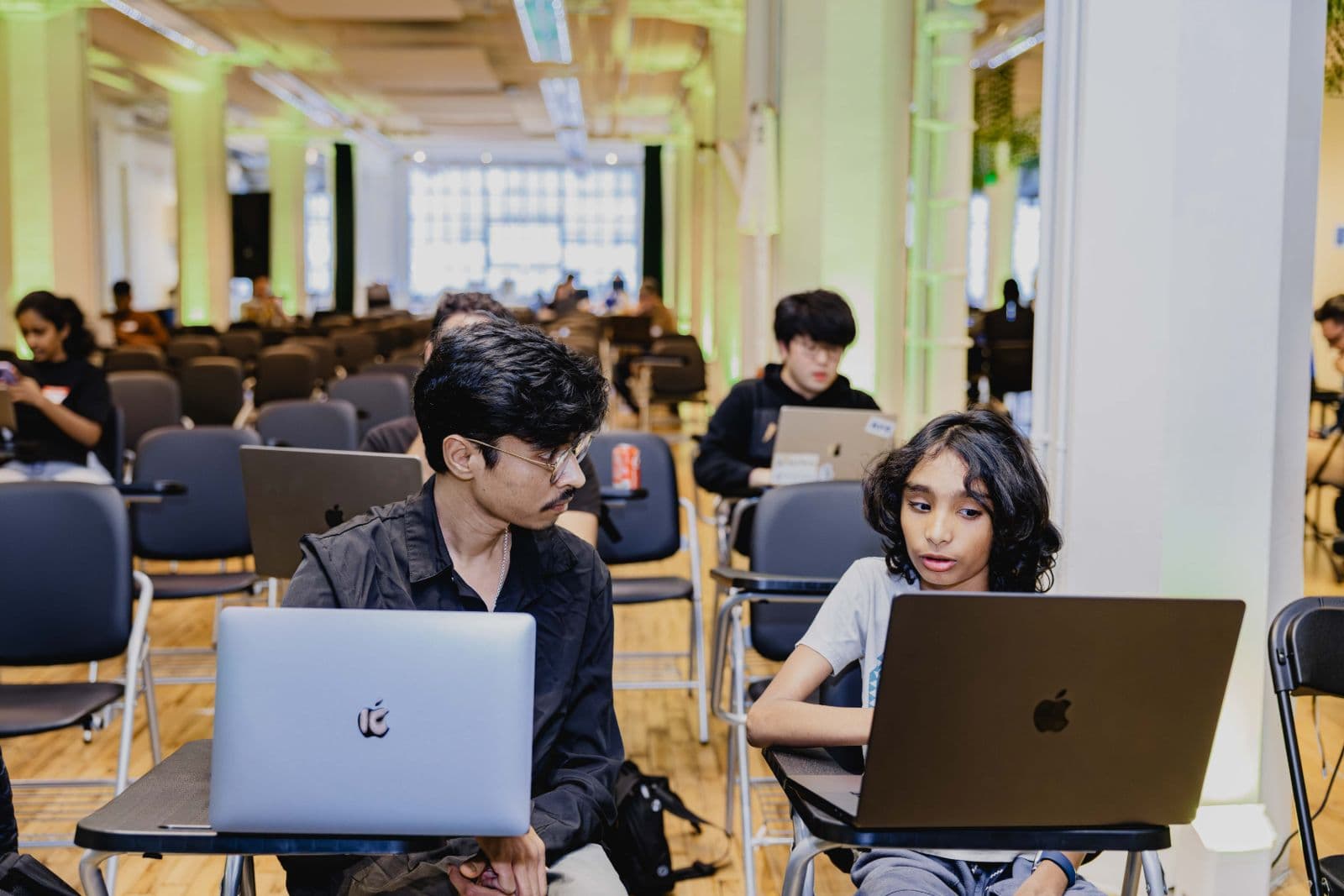 Developer team discussing strategy at TRAE Hackathon in Bay Area by JY Studio