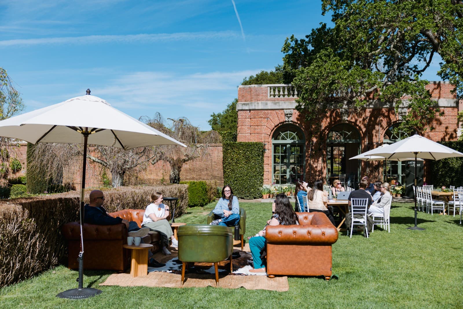 Zapier Outpost attendees gathering in Filoli Historic House main hall by JY Studio
