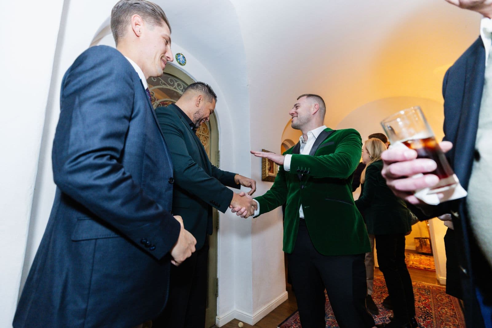 Guests mingling and networking at festive holiday party celebration in Oakland by JY Studio