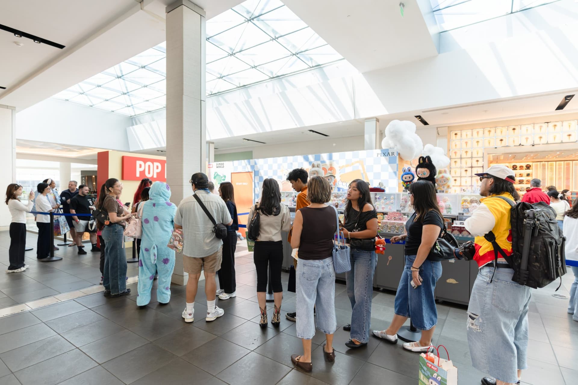 Collectors including a Sulley cosplayer waiting in line for the DIMOO signing at the Pop Mart DIMOO signing event at Westfield Valley Fair in Santa Clara by JY Studio