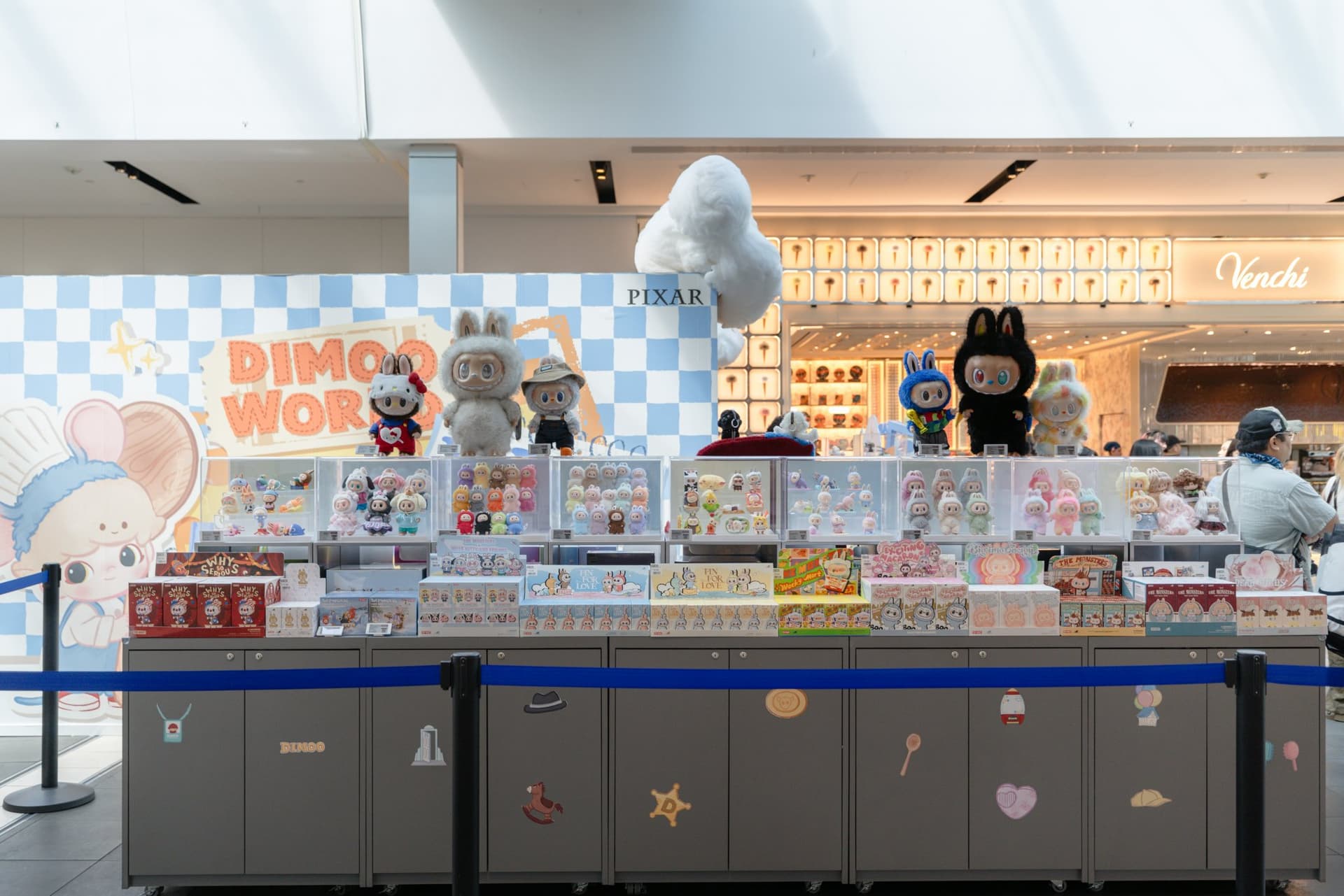 DIMOO WORLD x PIXAR pop-up counter with DIMOO figures and a giant DIMOO mouse display at the Pop Mart DIMOO WORLD x PIXAR pop-up at Westfield Valley Fair in Santa Clara by JY Studio