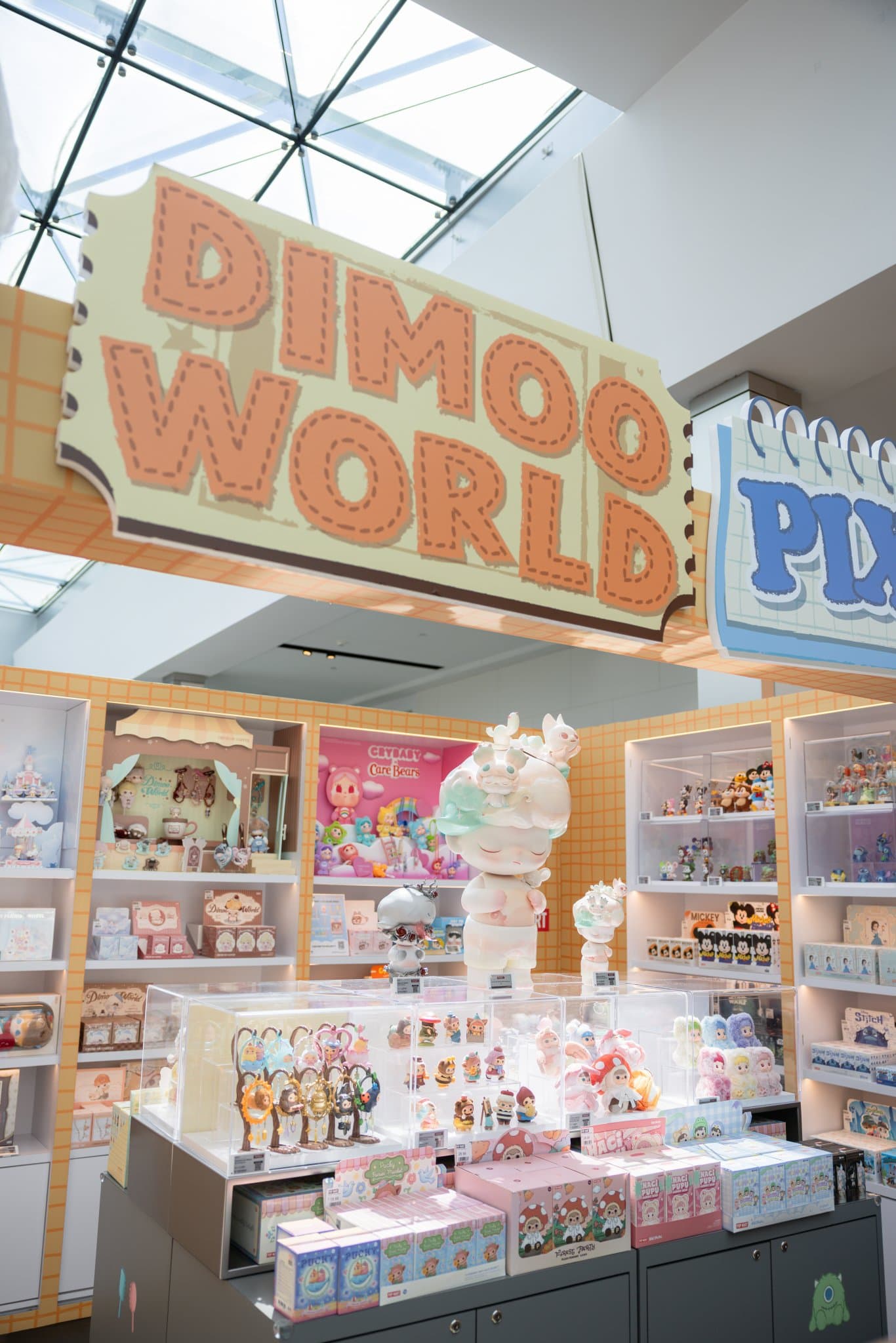 DIMOO WORLD sign over the pop-up display of DIMOO figures and blind boxes at the Pop Mart DIMOO WORLD x PIXAR pop-up at Westfield Valley Fair in Santa Clara by JY Studio