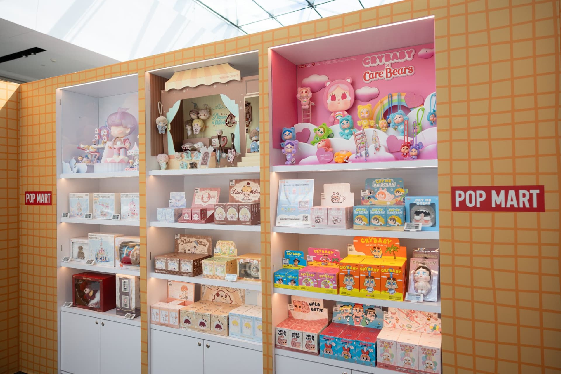 DIMOO and Pop Mart blind box shelves inside the pop-up at the Pop Mart DIMOO WORLD x PIXAR pop-up at Westfield Valley Fair in Santa Clara by JY Studio