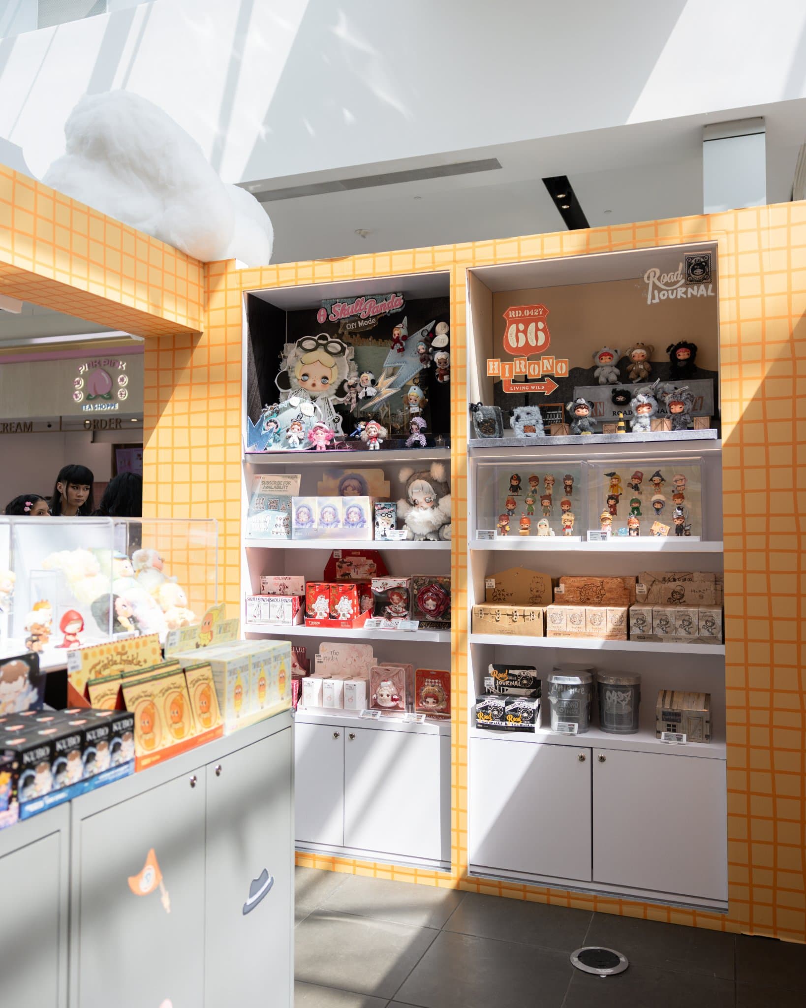 Pop Mart collectible shelves at the DIMOO WORLD pop-up at the Pop Mart DIMOO WORLD x PIXAR pop-up at Westfield Valley Fair in Santa Clara by JY Studio