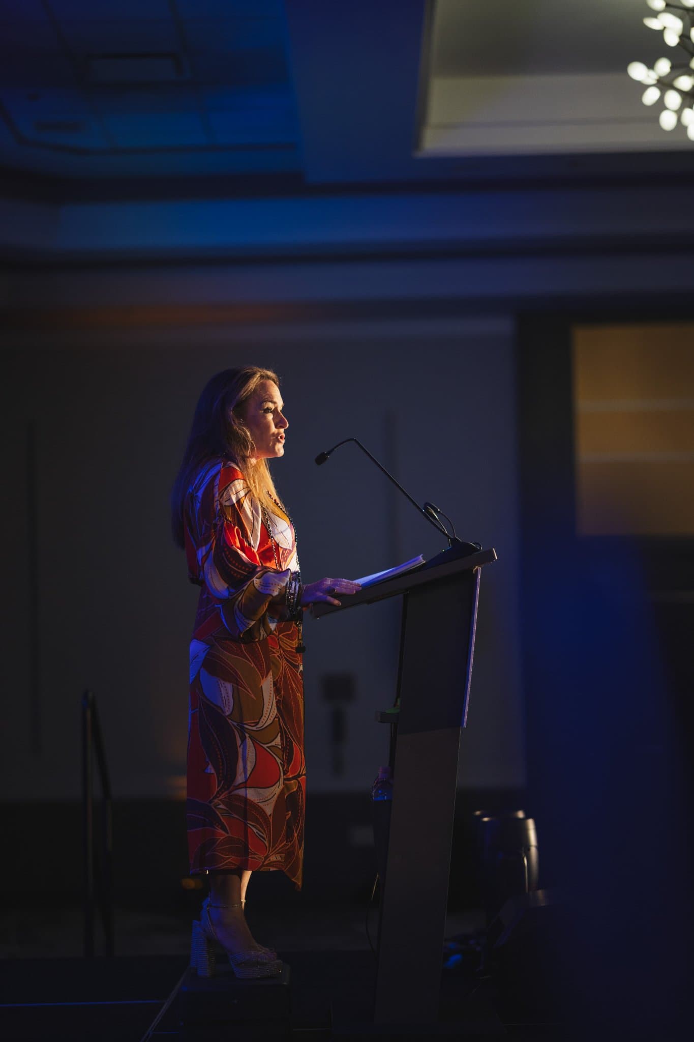 Full-length view of a speaker at the podium in the hotel ballroom at Admin Awards 2026 at SFO Marriott Waterfront, Burlingame by JY Studio
