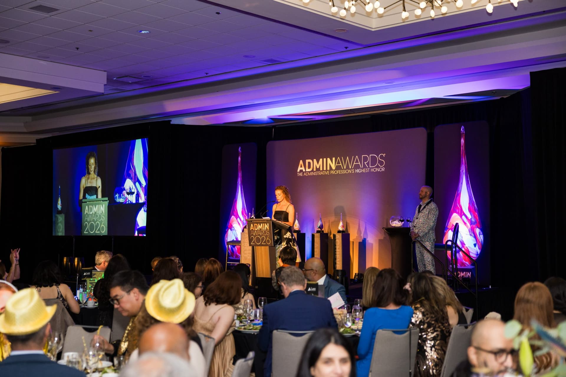 Wide view of the packed ballroom with guests at banquet tables watching the awards stage at Admin Awards 2026 at SFO Marriott Waterfront, Burlingame by JY Studio