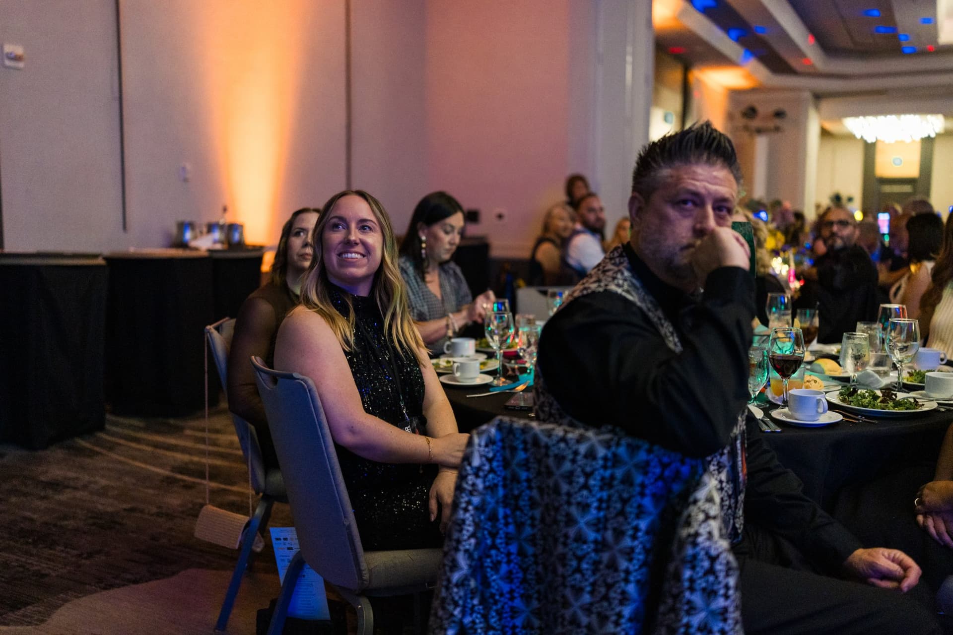 Guests at a banquet table turning to watch the awards ceremony at Admin Awards 2026 at SFO Marriott Waterfront, Burlingame by JY Studio