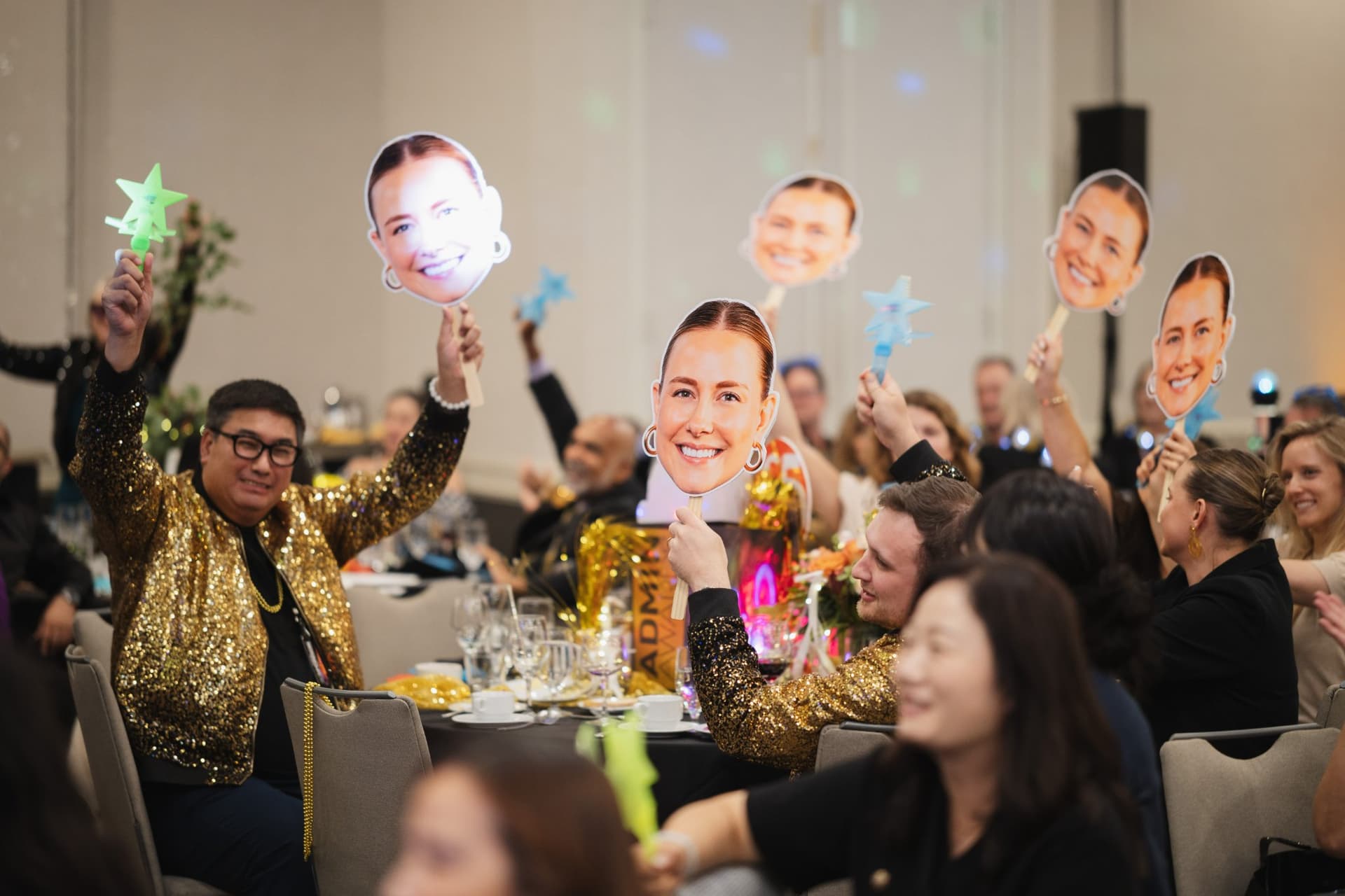 Supporters cheering with nominee face cutouts and light-up star wands at Admin Awards 2026 at SFO Marriott Waterfront, Burlingame by JY Studio