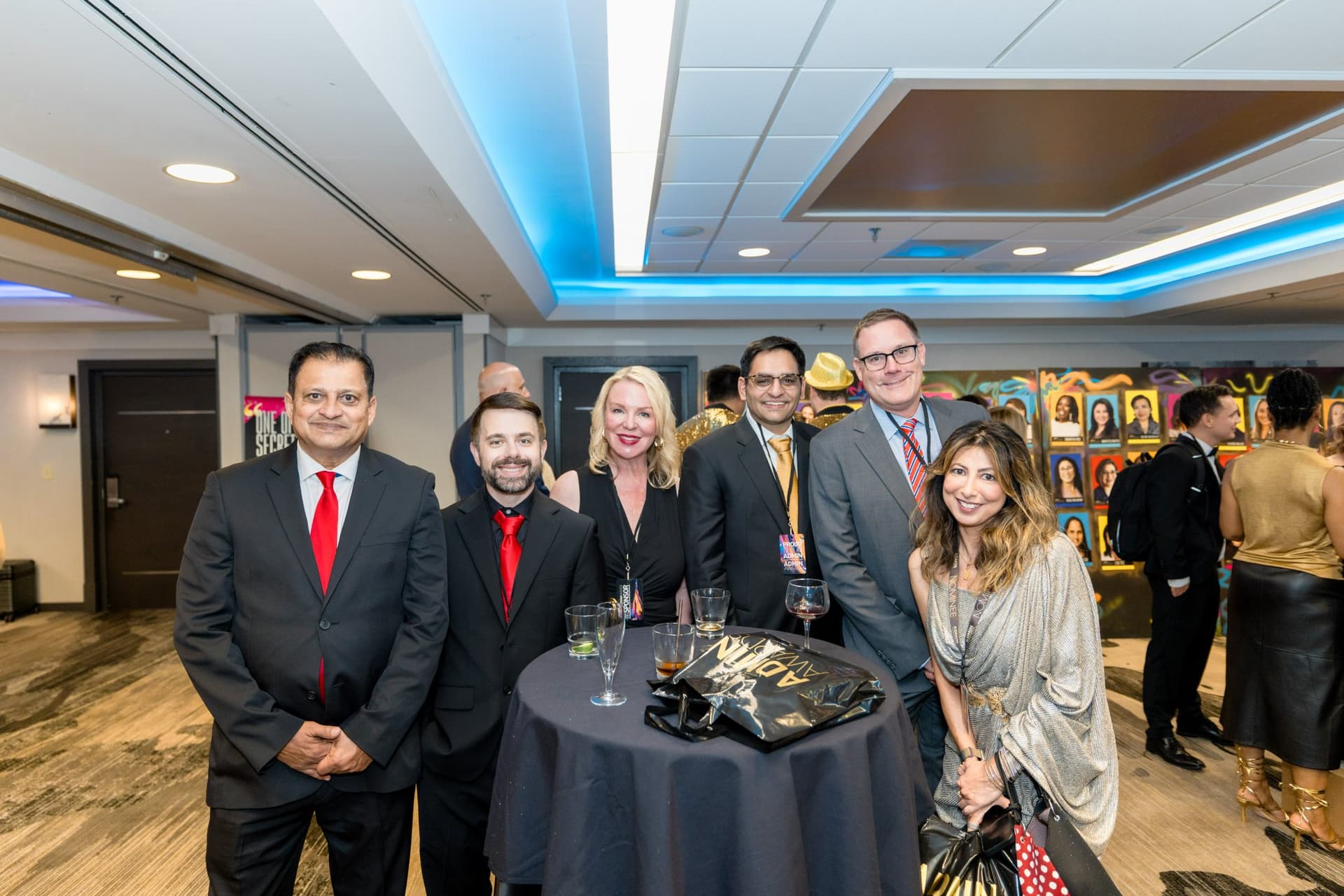 Guests posing around a cocktail table during the pre-gala reception at Admin Awards 2026 at SFO Marriott Waterfront, Burlingame by JY Studio