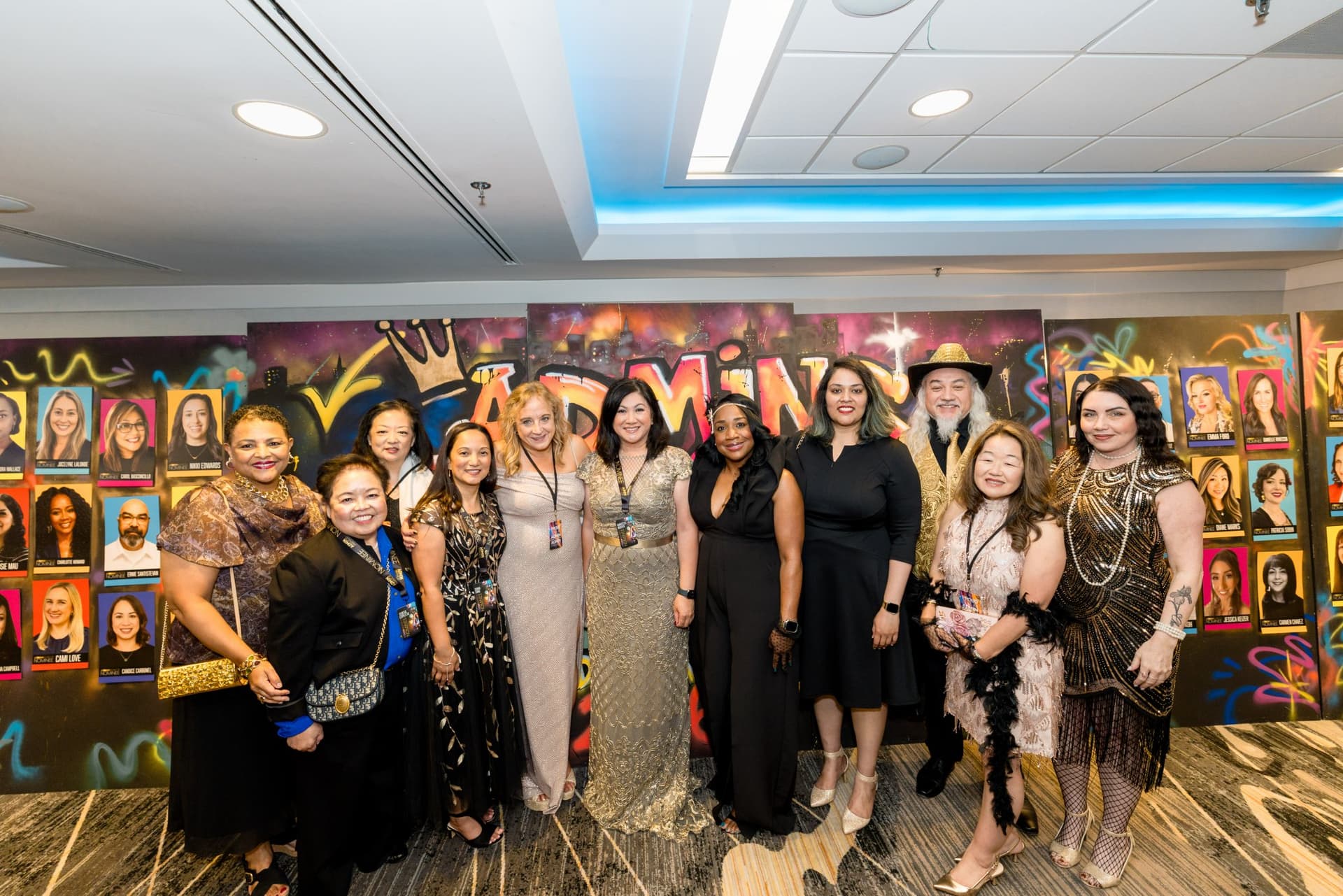 Group of guests posing in front of the graffiti-style nominee portrait wall at Admin Awards 2026 at SFO Marriott Waterfront, Burlingame by JY Studio