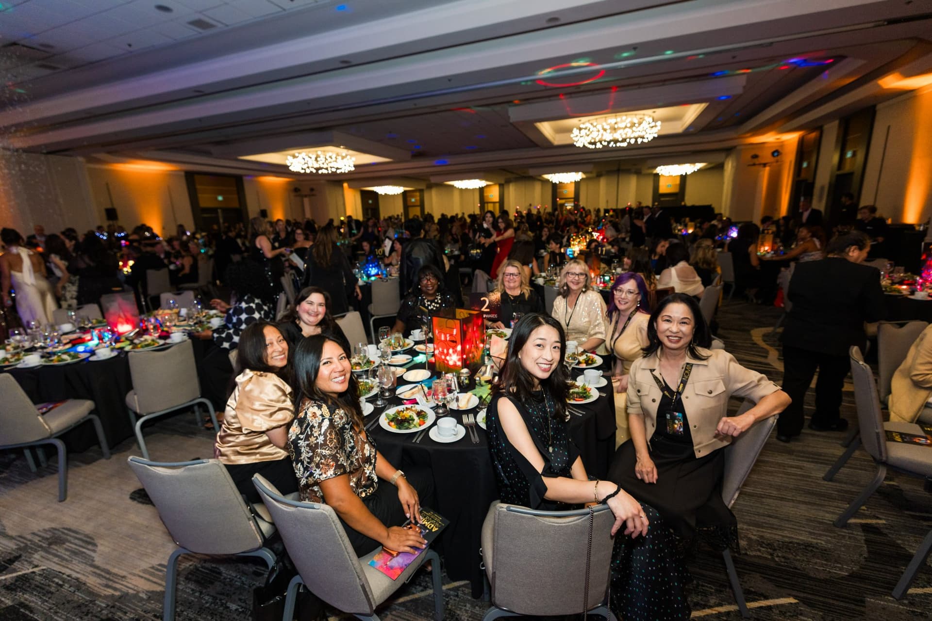 Smiling table of guests in the packed ballroom during dinner at Admin Awards 2026 at SFO Marriott Waterfront, Burlingame by JY Studio