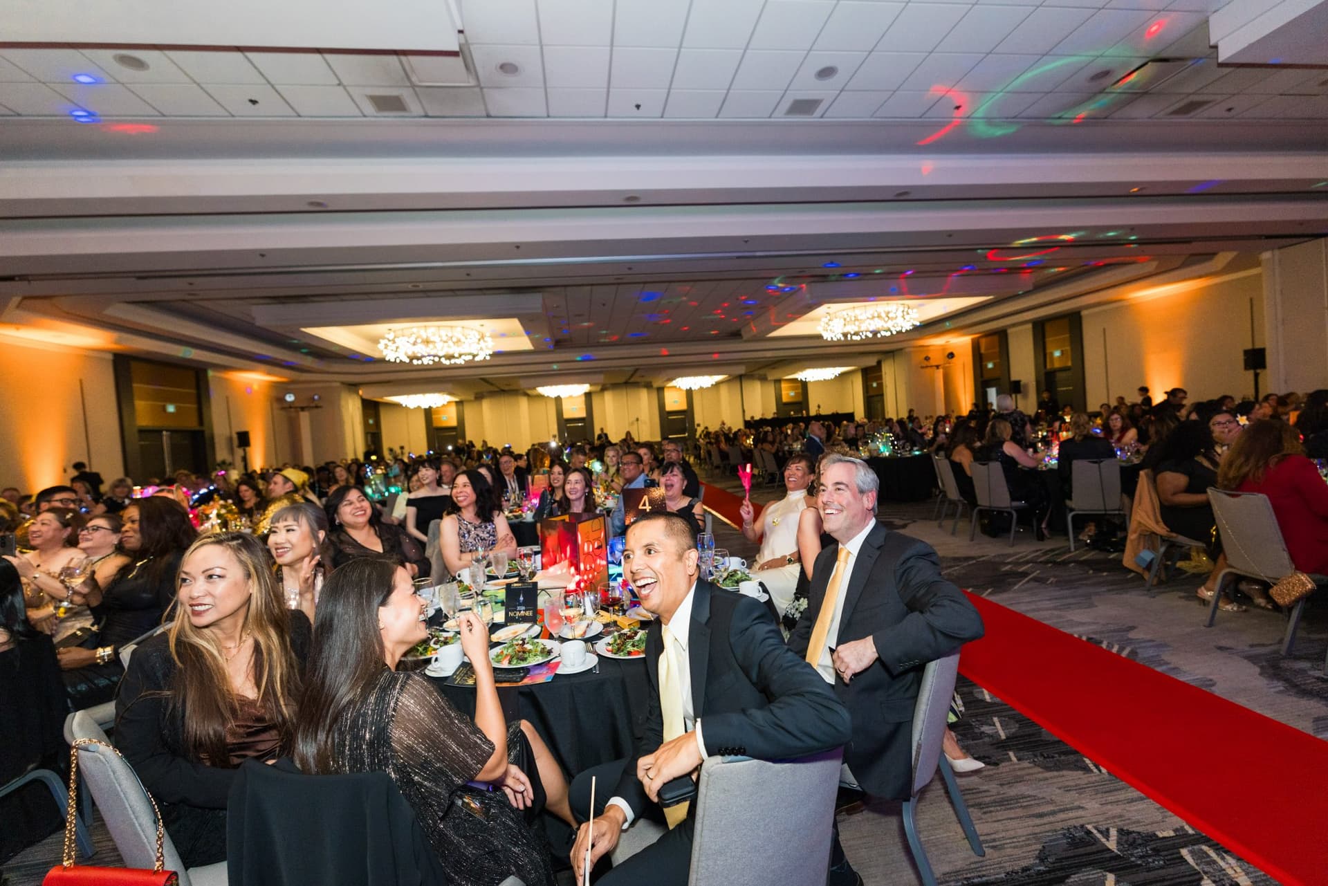 Guests smiling at their tables beside the red carpet aisle at Admin Awards 2026 at SFO Marriott Waterfront, Burlingame by JY Studio
