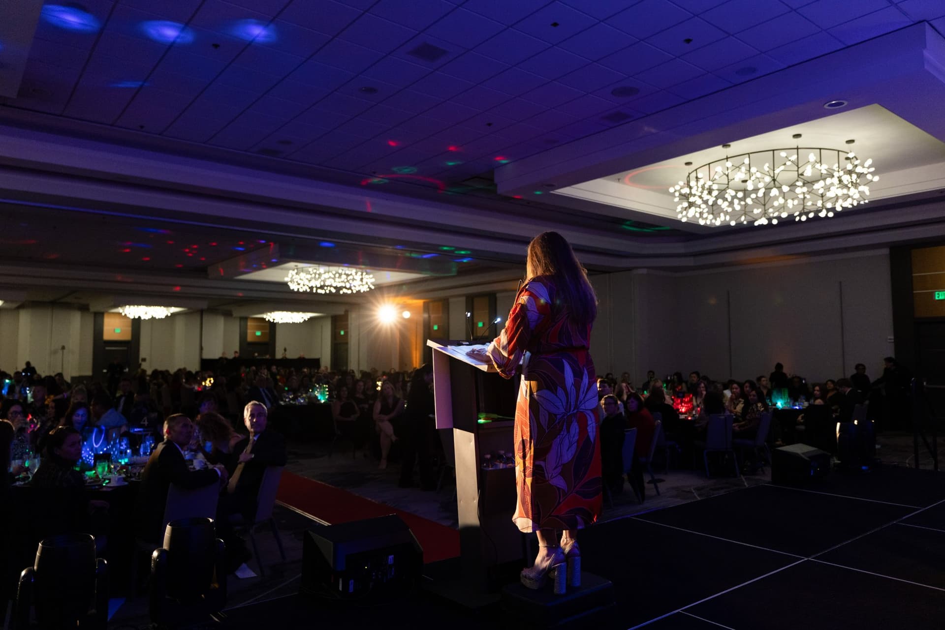 Speaker at the podium addressing the full ballroom of guests at Admin Awards 2026 at SFO Marriott Waterfront, Burlingame by JY Studio