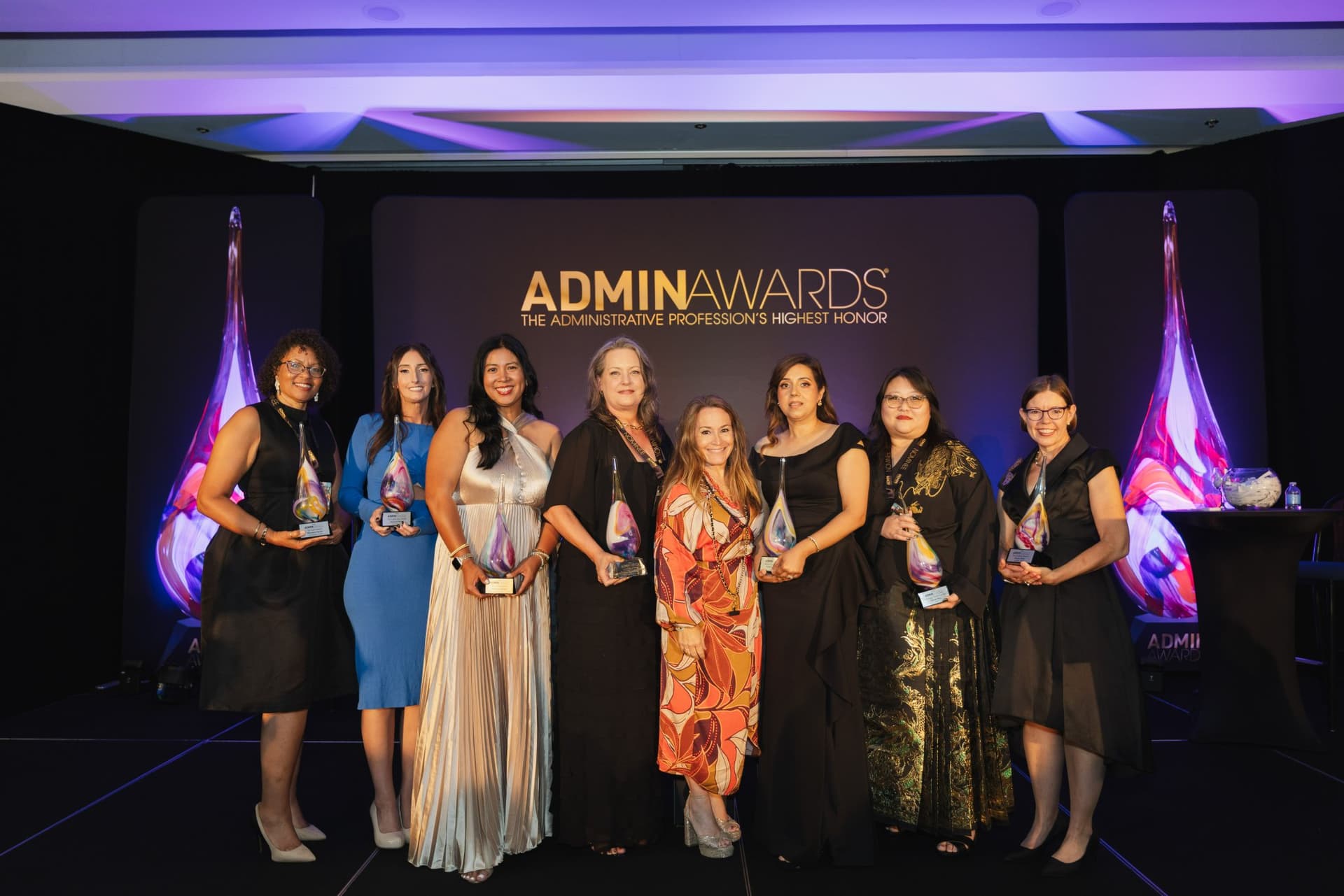 Group photo of the 2026 Admin Awards winners holding their trophies on stage at Admin Awards 2026 at SFO Marriott Waterfront, Burlingame by JY Studio