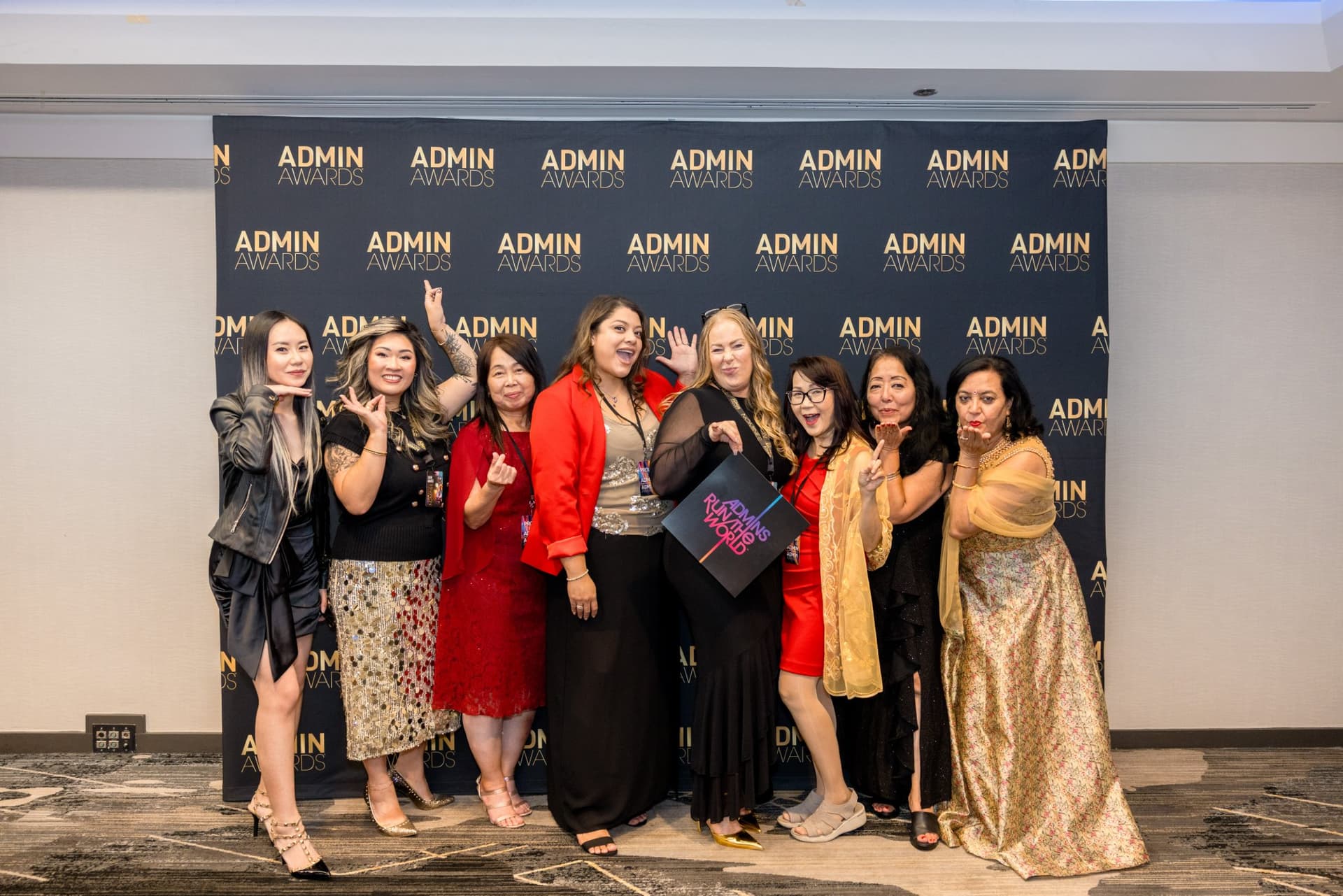 Group of guests striking playful poses at the Admin Awards step-and-repeat at Admin Awards 2026 at SFO Marriott Waterfront, Burlingame by JY Studio